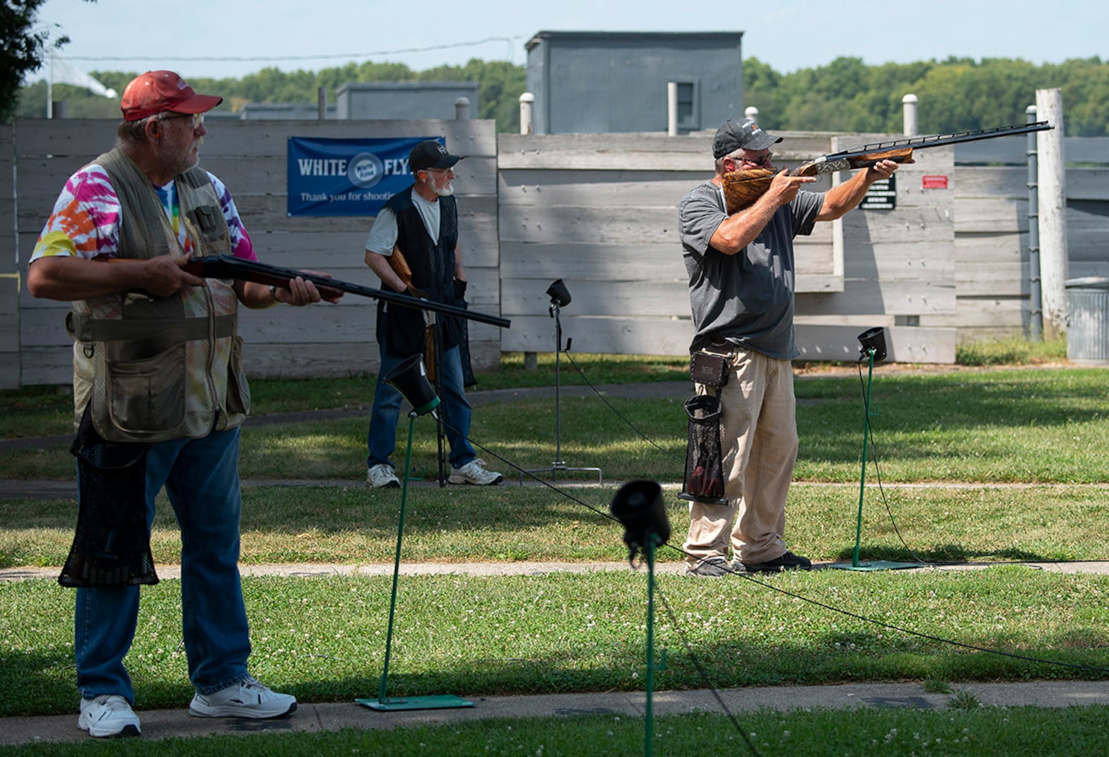 Retiree Trap League competitors take turns firing at clay pigeons Aug. 24 on the Rod and Gun Club range at Wright-Patterson Air Force Base. Microphones pick up their command to “Pull!” — triggering the voice-activated machine to launch the disk. U.S. AIR FORCE PHOTO/R.J. ORIEZ