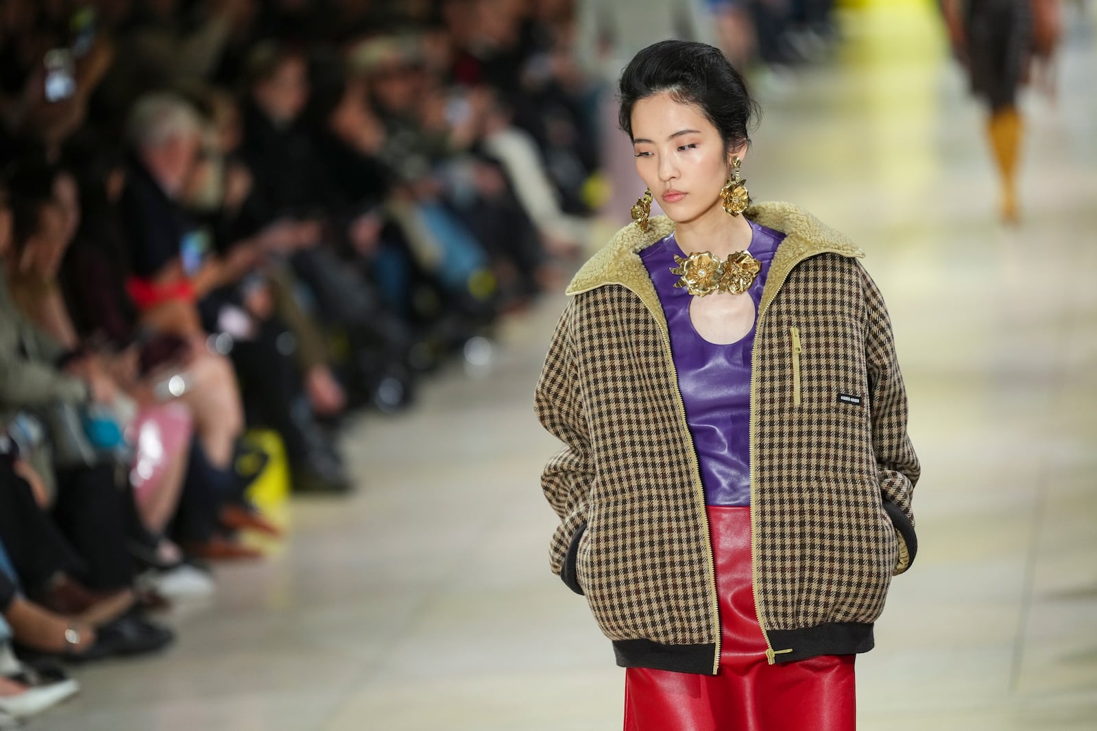 A model wears a creation as part of the Miu Miu Fall/Winter 2025-2026 Womenswear collection presented Tuesday, March 11, 2025. in Paris. (Photo by Scott A Garfitt/Invision/AP)