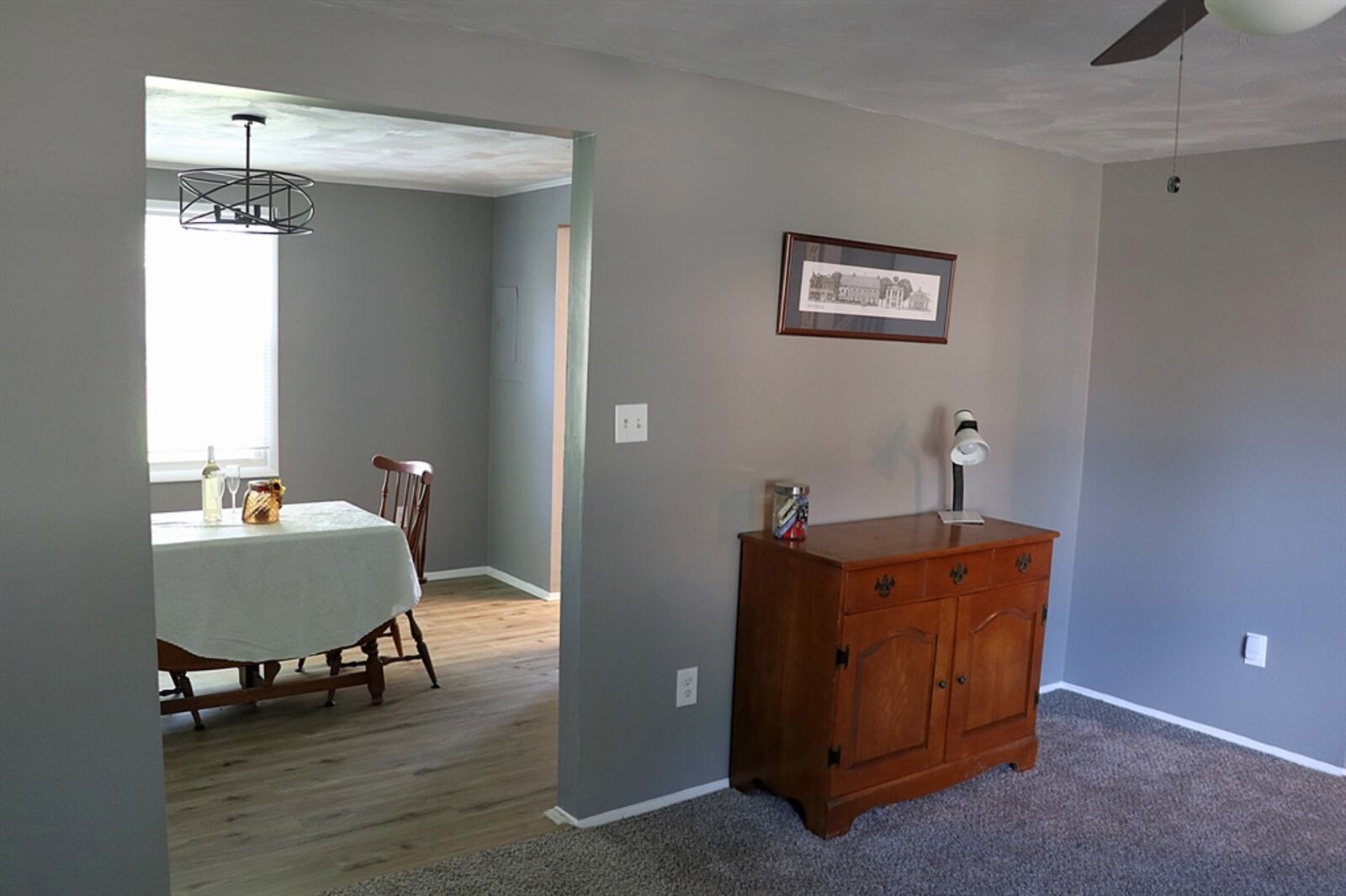 The living room and the dining room have updated ceiling light fixtures. 