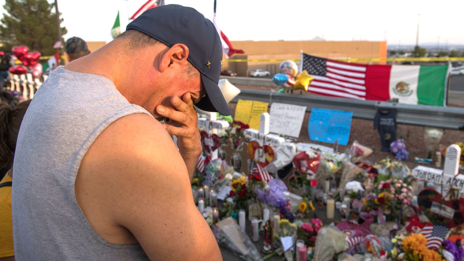 A man prays at a makeshift memorial for 22 people gunned down Aug. 3, 2019, at a Walmart in El Paso, Texas. The gunman's 23rd victim, Guillermo “Memo” Garcia, died Saturday, April 25, 2020, nearly nine months after the massacre. (Mark Ralston/AFP via Getty Images)