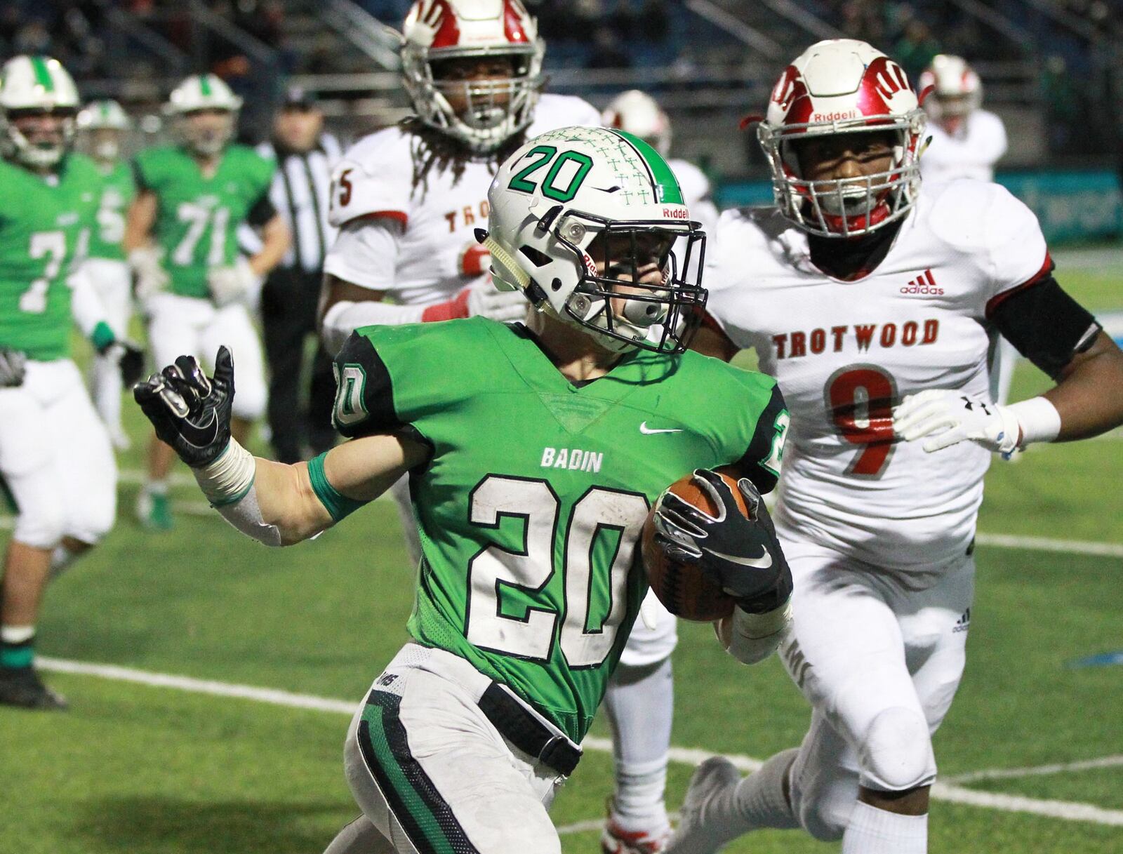 Alex DeLong of Badin (20) turns the corner on Daylen Morgan of Trotwood (9). Trotwood-Madison defeated Badin 20-7 in a D-III, Region 12 high school football final at Miamisburg on Friday, Nov. 22, 2019. MARC PENDLETON / STAFF