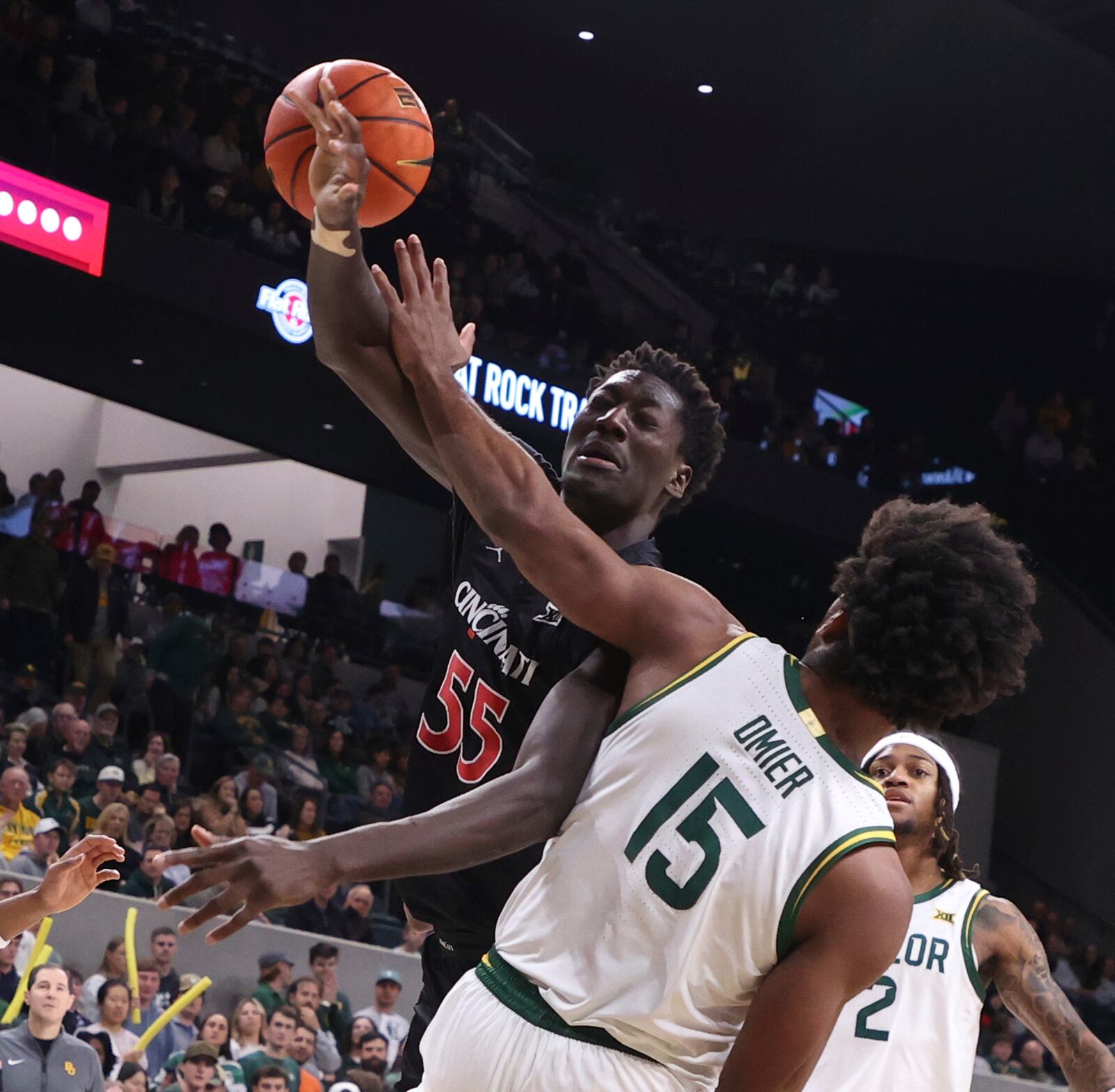 Cincinnati forward Aziz Bandaogo battles Baylor forward Norchad Omier for a loose ball in the first half of an NCAA college basketball game, Tuesday, Jan. 7, 2025, in Waco, Texas. (Rod Aydelotte/Waco Tribune-Herald via AP)