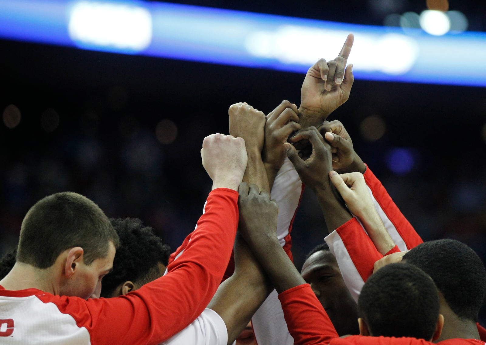 Dayton players huddle before a game against Oklahoma in the third round of the NCAA tournament on Sunday, March 22, 2015, at Nationwide Arena in Columbus. David Jablonski/Staff