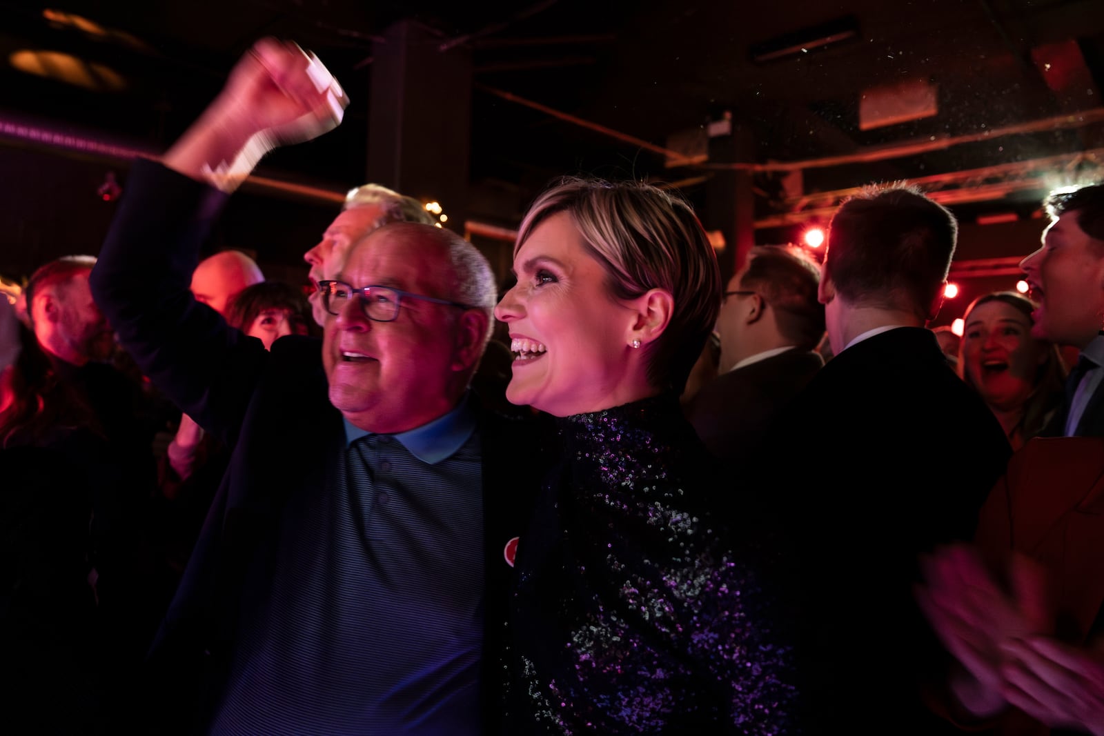 Kristrún Mjöll Frostadóttir, leader of the Samfylking, Social Democratic party, right, celebrates with a supporter at the celebration party following the closure of the polling stations in Reykjavik, Saturday Nov. 30, 2024. (AP Photo/Marco di Marco)