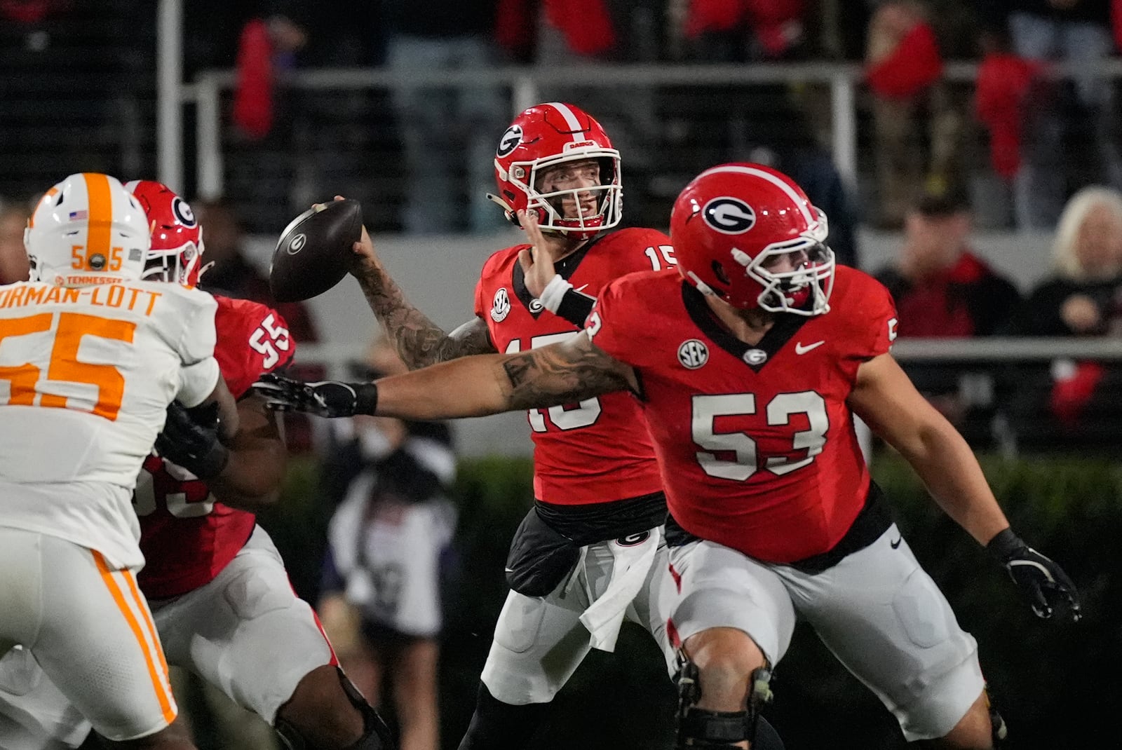 Georgia quarterback Carson Beck (15) throws from behind offensive lineman Dylan Fairchild (53) during the first half of an NCAA college football game against Tennessee , Saturday, Nov. 16, 2024, in Athens, Ga. (AP Photo/John Bazemore)