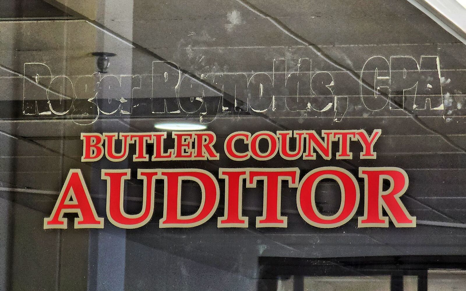 Roger Reynolds name has been removed from the door of the Butler County Auditor's Office on High Street in Hamilton. NICK GRAHAM/STAFF