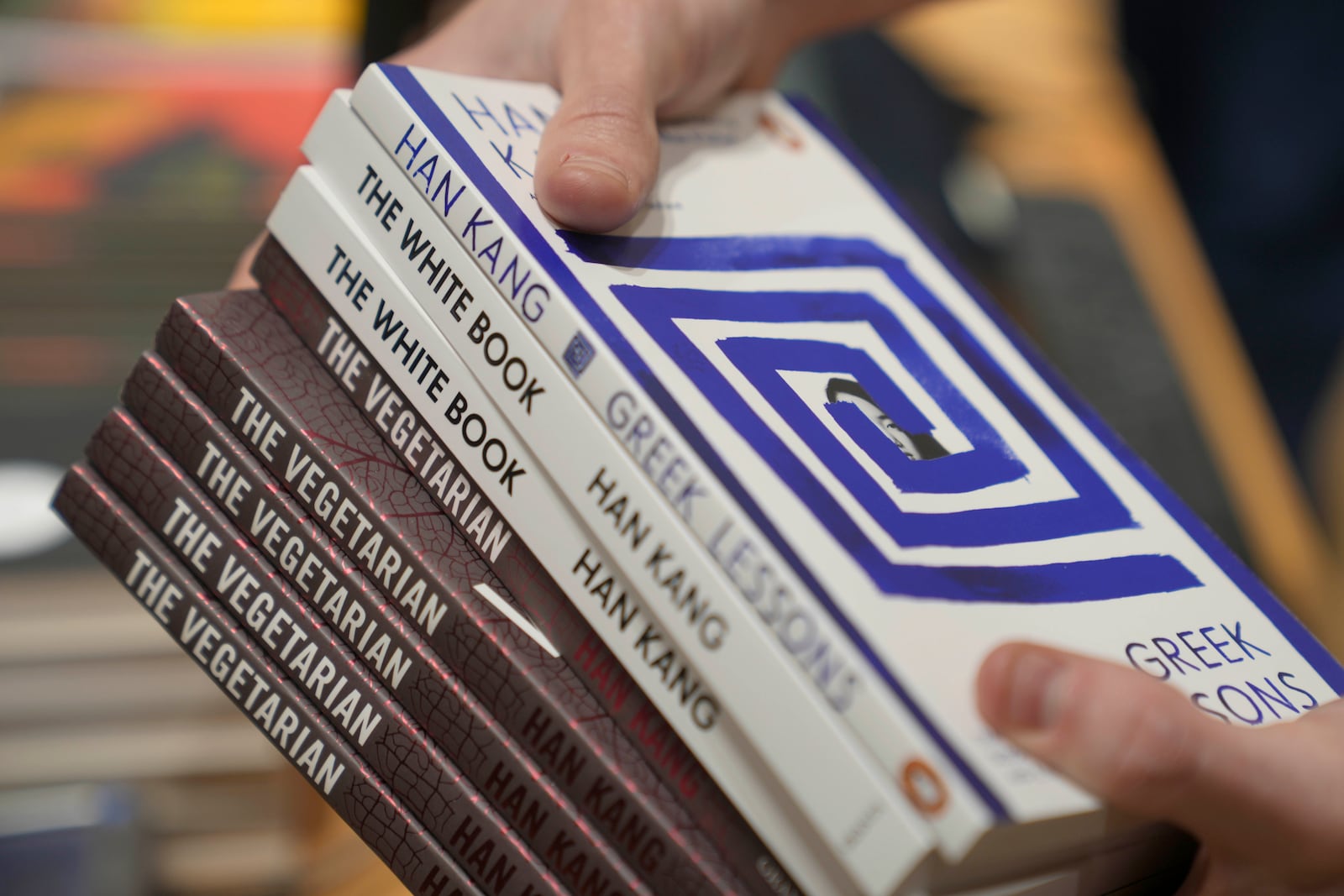 A book store employee handles books by the South Korean writer Han Kang in London, Thursday, Oct. 10, 2024. Kang has been awarded the Nobel Prize for Literature. (AP Photo/Kin Cheung)