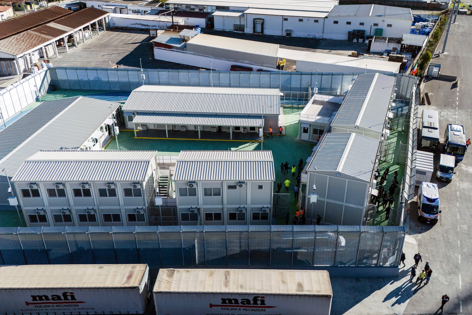 An aerial view of a migrant reception facility at the port of Shengjin, northwestern Albania, Friday, Nov. 8, 2024, before a second group of eight migrants intercepted in international waters is processed to the facility despite the failure with the first group in October. (AP Photo/Vlasov Sulaj)