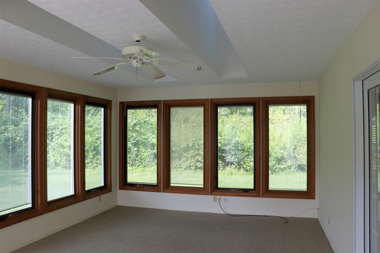 Triple patio doors open into the garden room, which could easily be a four-season room. 