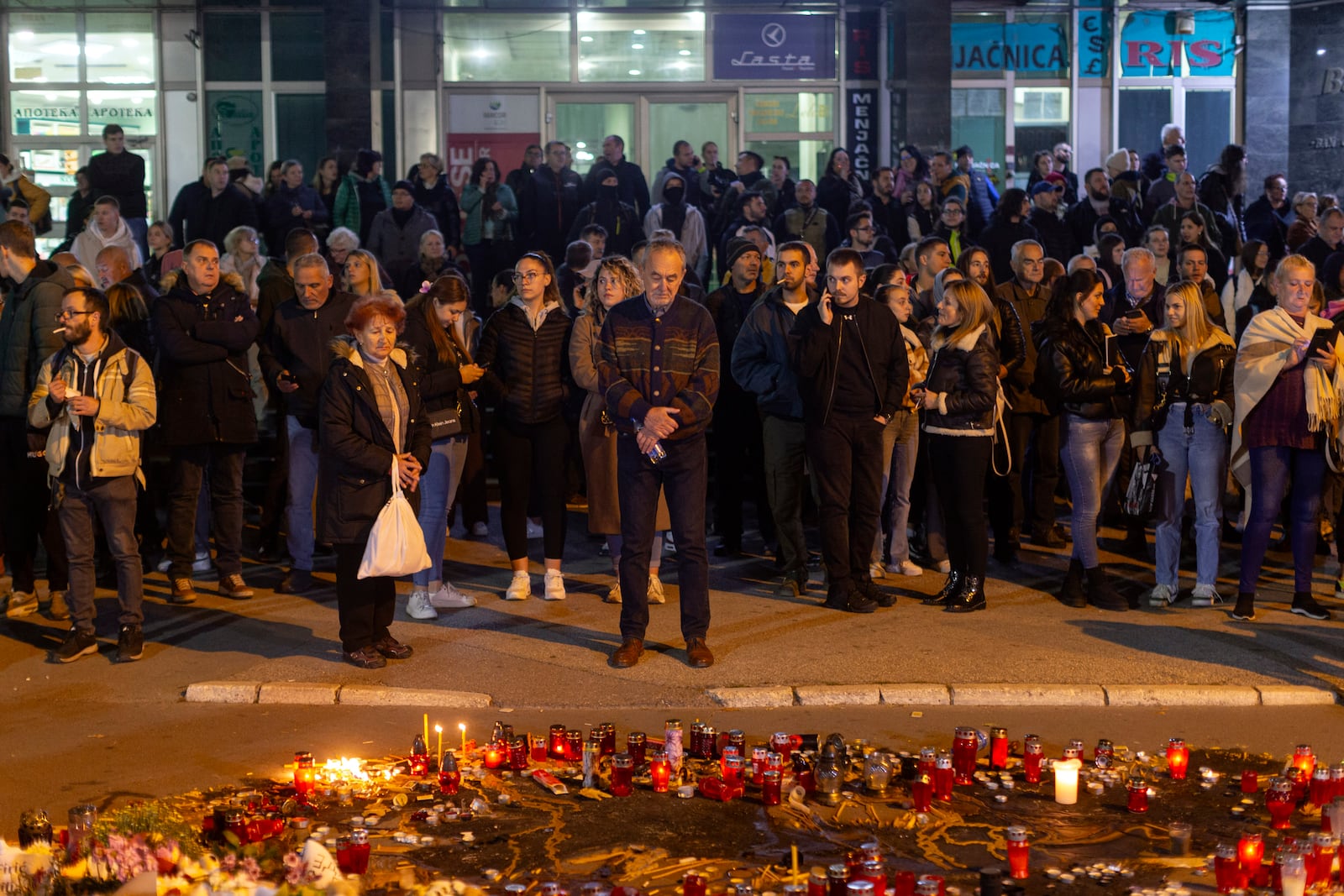 People pay respect to the 14 people killed at a local rail station during a protest in Novi Sad, Serbia, Tuesday, Nov. 5, 2024. (AP Photo/Marko Drobnjakovic)