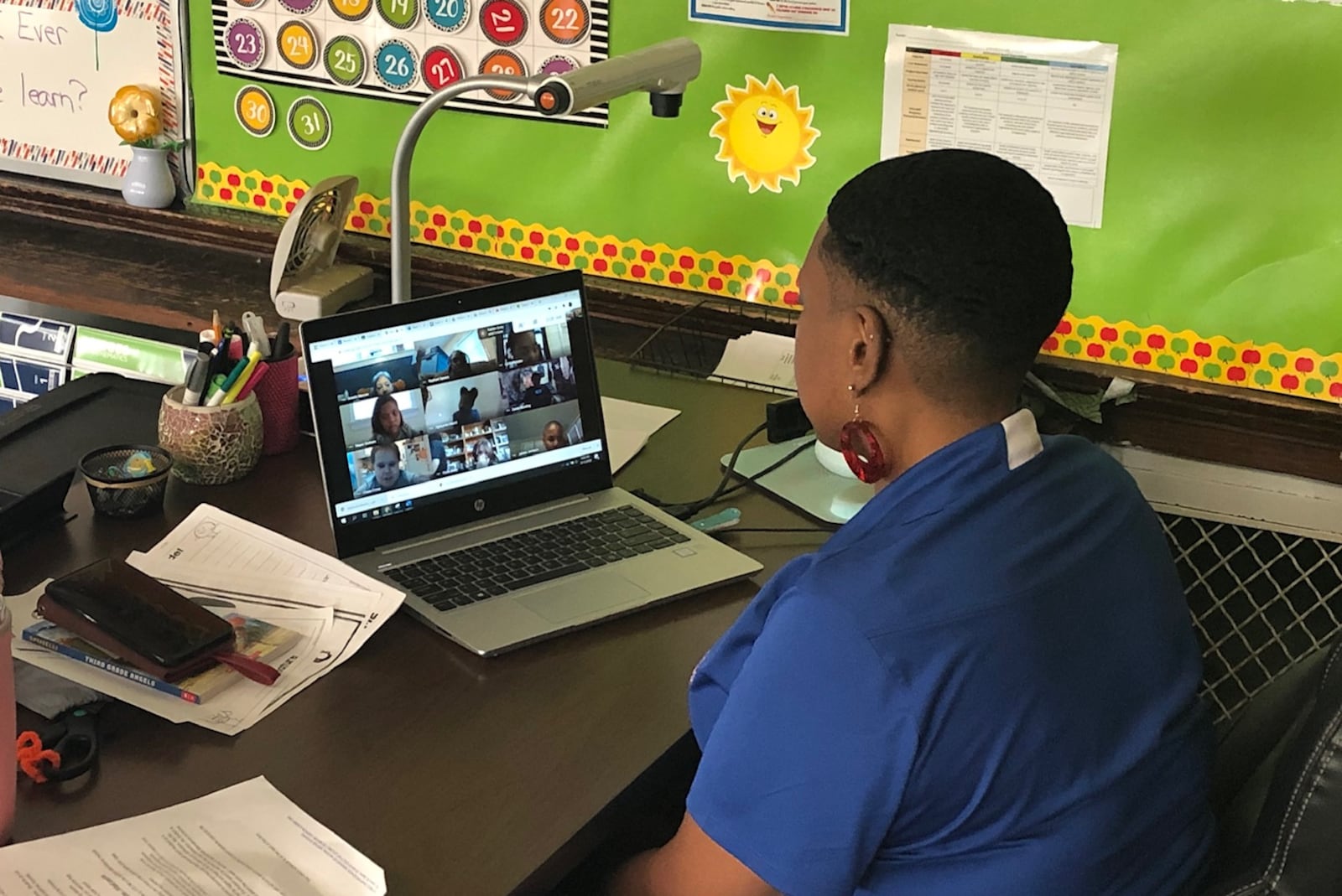 Emerson Academy third-grade teacher Michelle Saunders has a live session with her students through her laptop computer on Wednesday, Aug. 12, 2020 in Dayton.