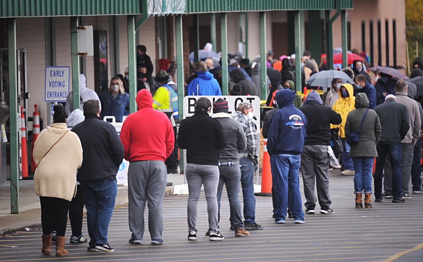 The rain and the cold weather on Friday, Oct. 30, 2020, did not stop voters in Greene County from lining up to vote early in Xenia. MARSHALL GORBY\STAFF