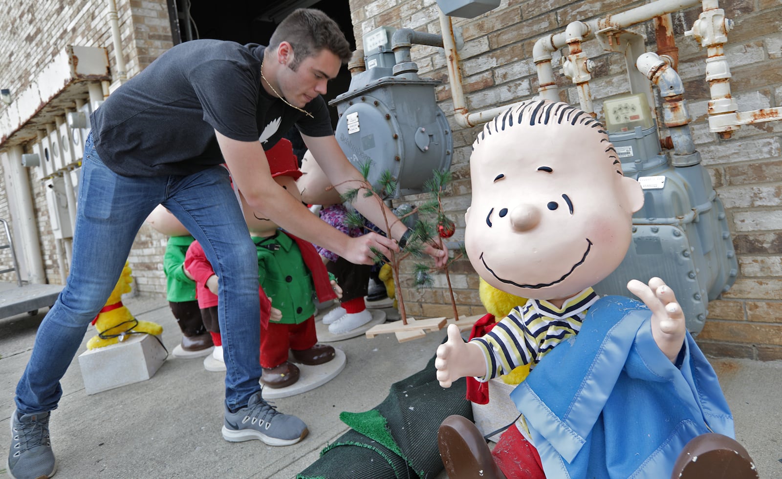 Jonathan Golden, an intern from Wittenberg University, brings "Peanuts" characters out from the Upper Valley Mall storage room Wednesday. The Clark County Land Bank donated the Upper Valley Mall's holiday display to the Clark County Historical Society. BILL LACKEY/STAFF