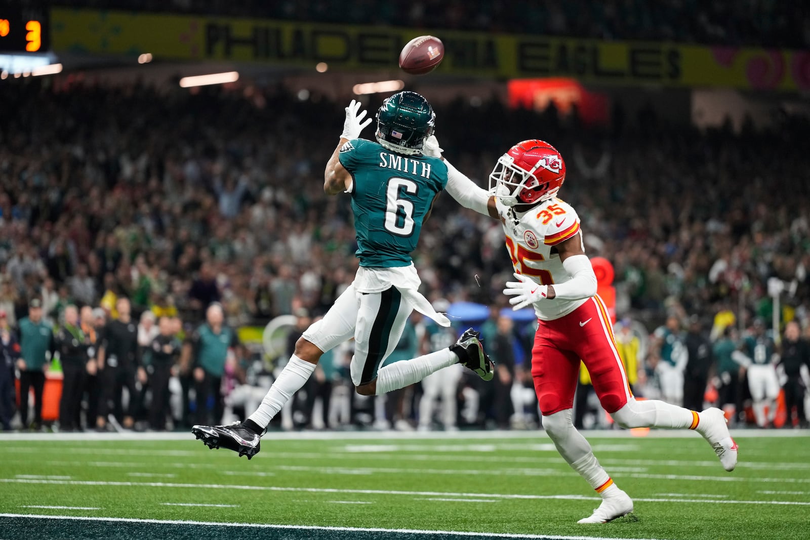 Philadelphia Eagles wide receiver DeVonta Smith (6) makes a touchdown catch past Kansas City Chiefs cornerback Jaylen Watson (35) during the second half of the NFL Super Bowl 59 football game, Sunday, Feb. 9, 2025, in New Orleans. (AP Photo/Abbie Parr)