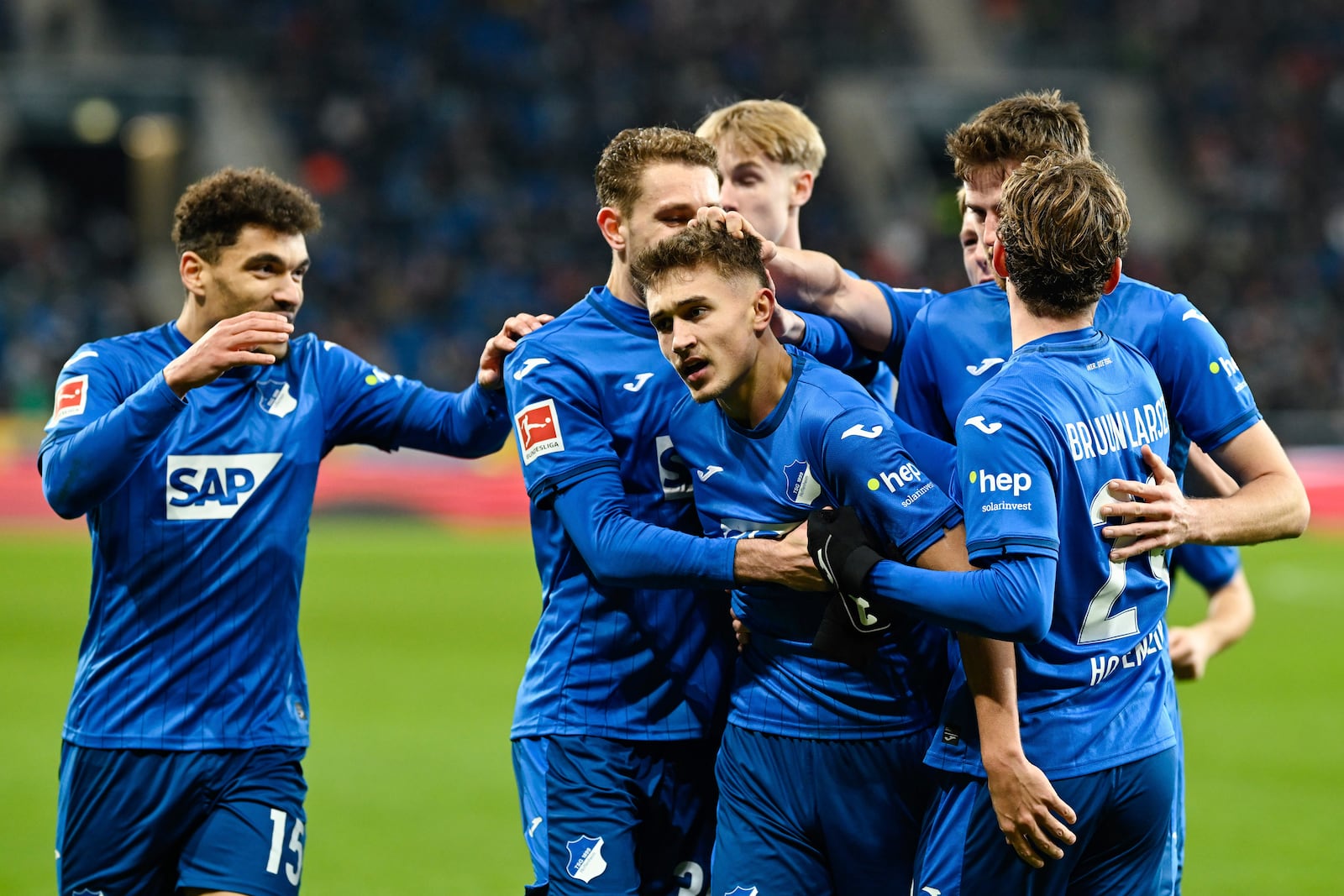 Hoffenheim's Tom Bischof, third from left, celebrates with teammates after scoring during the German Bundesliga soccer match between TSG 1899 Hoffenheim and SC Freiburg at the PreZero Arena, in Sinsheim, Germany, Sunday, Dec. 8, 2024. (Uwe Anspach/dpa via AP)