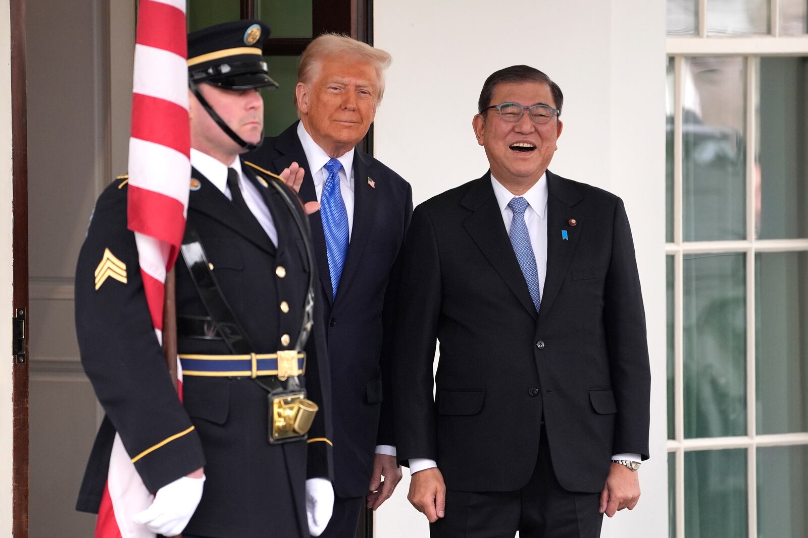 President Donald Trump, center, greets Japan's Prime Minister Shigeru Ishiba, right, at the White House, Friday, Feb. 7, 2025, in Washington. (AP Photo/Evan Vucci)