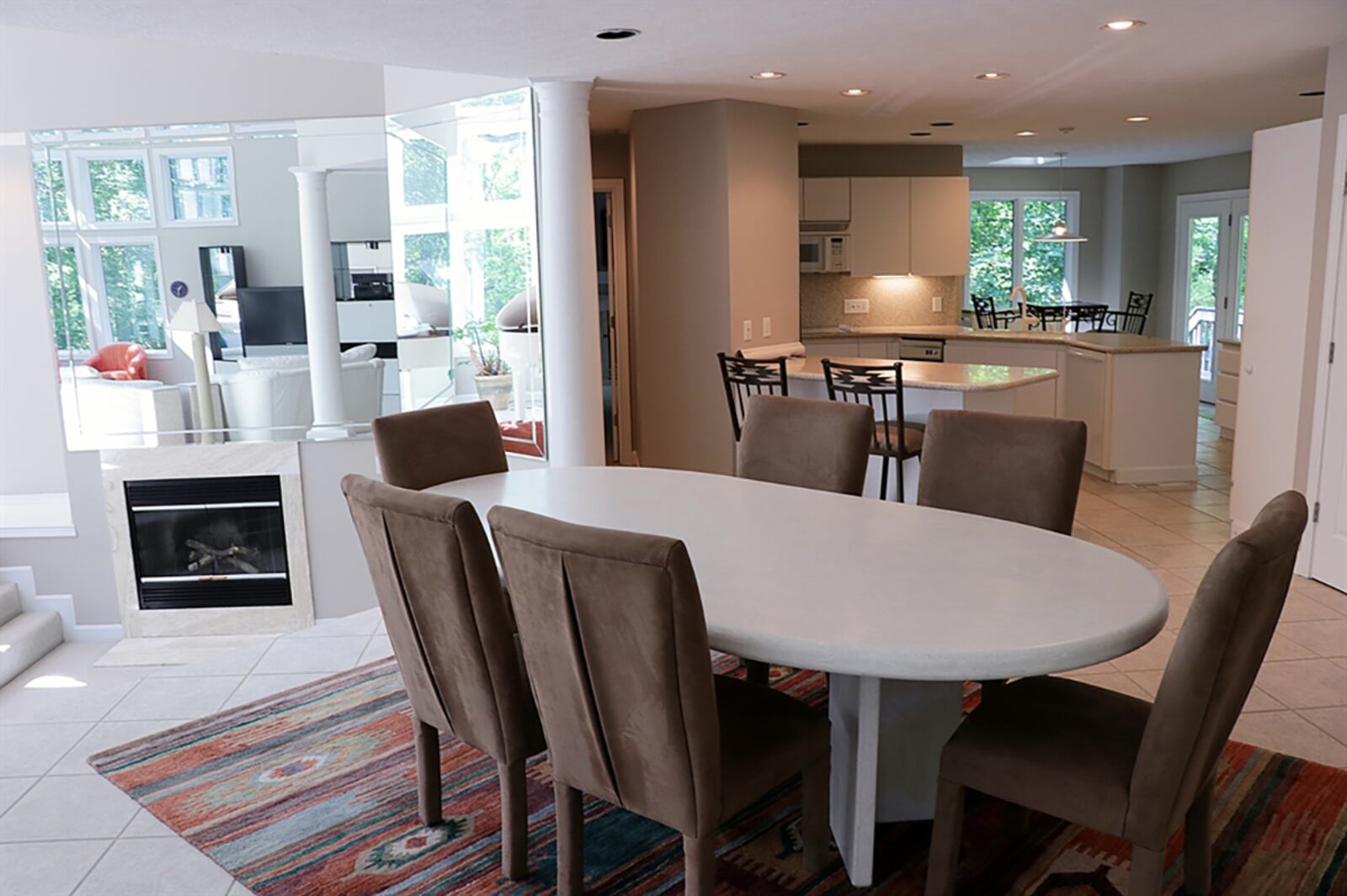 Pillars accent the dining room space, which is tucked under an upstairs loft. The ceiling increases to two stories above the great room, which is divided into a living room area, a sunny music area and a conversation pit next to the gas fireplace. CONTRIBUTED PHOTO BY KATHY TYLER