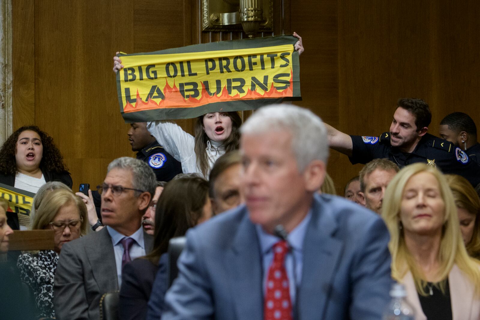 A protestor interrupts Chris Wright, President-elect Donald Trump's nominee to be Secretary of Energy, as he testifies during a Senate Committee on Energy and Natural Resources hearing for his pending confirmation, on Capitol Hill, Wednesday, Jan. 15, 2025, in Washington. (AP Photo/Rod Lamkey, Jr.)