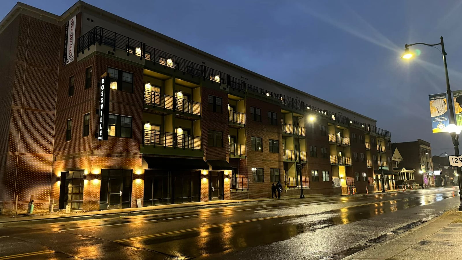 Pictured is Rossville Flats apartments on Main Street in Hamilton is seen at night Oct. 5, 2023, the day the sign was placed on the building. The apartment building opened in late 2023. MICHAEL D. PITMAN/STAFF