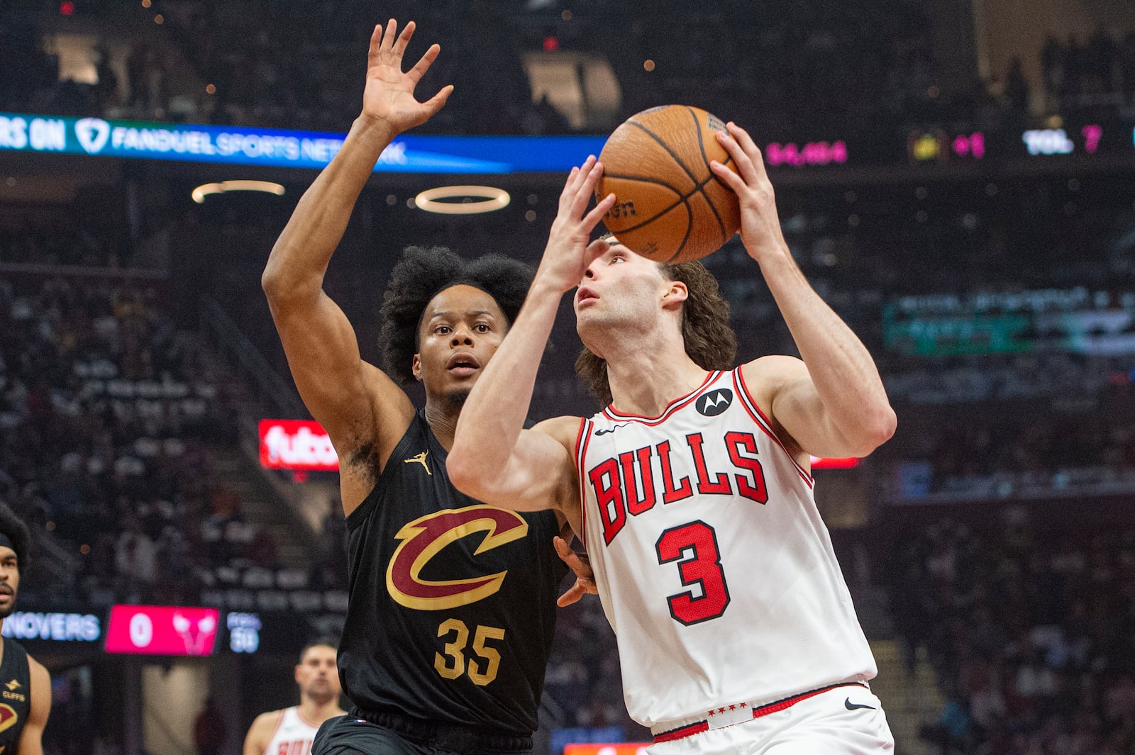 Chicago Bulls' Josh Giddey (3) drives as Cleveland Cavaliers' Isaac Okoro (35) defends during the first half of an Emirates NBA Cup basketball game in Cleveland, Friday, Nov 15, 2024. (AP Photo/Phil Long)