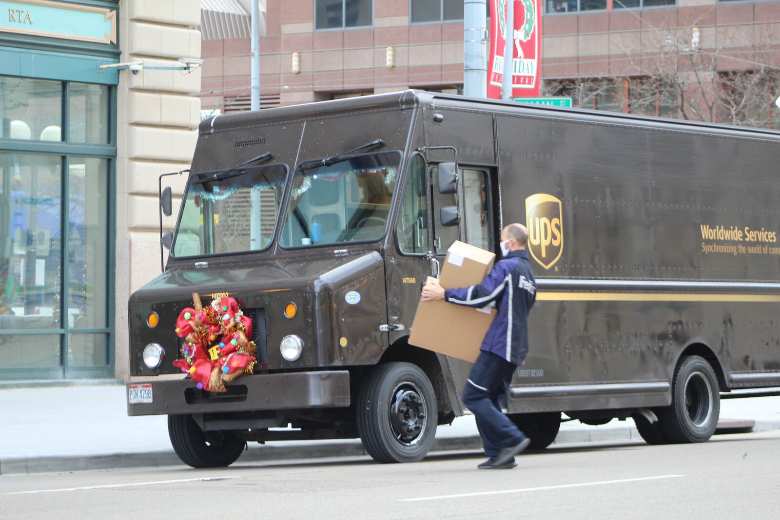 A FedEx delivery driver drops off packages in downtown Dayton at the same time as a UPS delivery in 2020. Both companies have local job openings posted on their websites. CORNELIUS FROLIK / STAFF