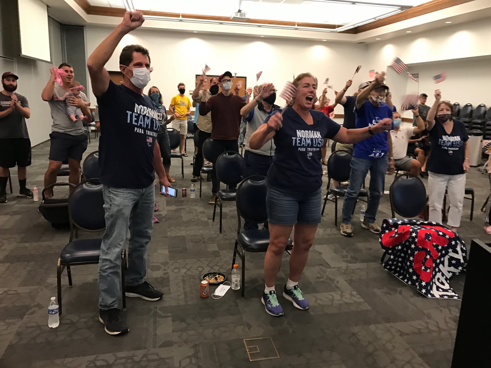 Grace Norman's parents, Tim and Robin, cheer her on from a watch party at Cedarville University during Saturday night's paralympic triathlon event. Tom Archdeacon/STAFF