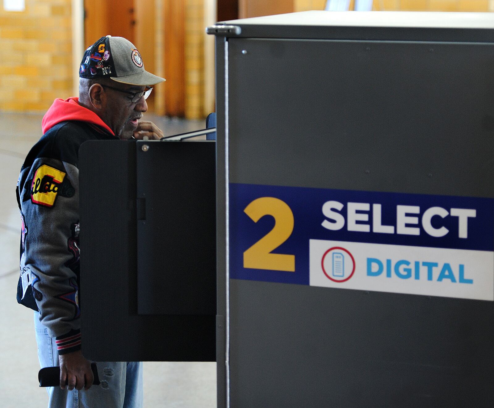 Guy Sanford, reads over his ballot Tuesday, March 19, 2024 at the Grace United Methodist Church in Dayton. MARSHALL GORBY\STAFF