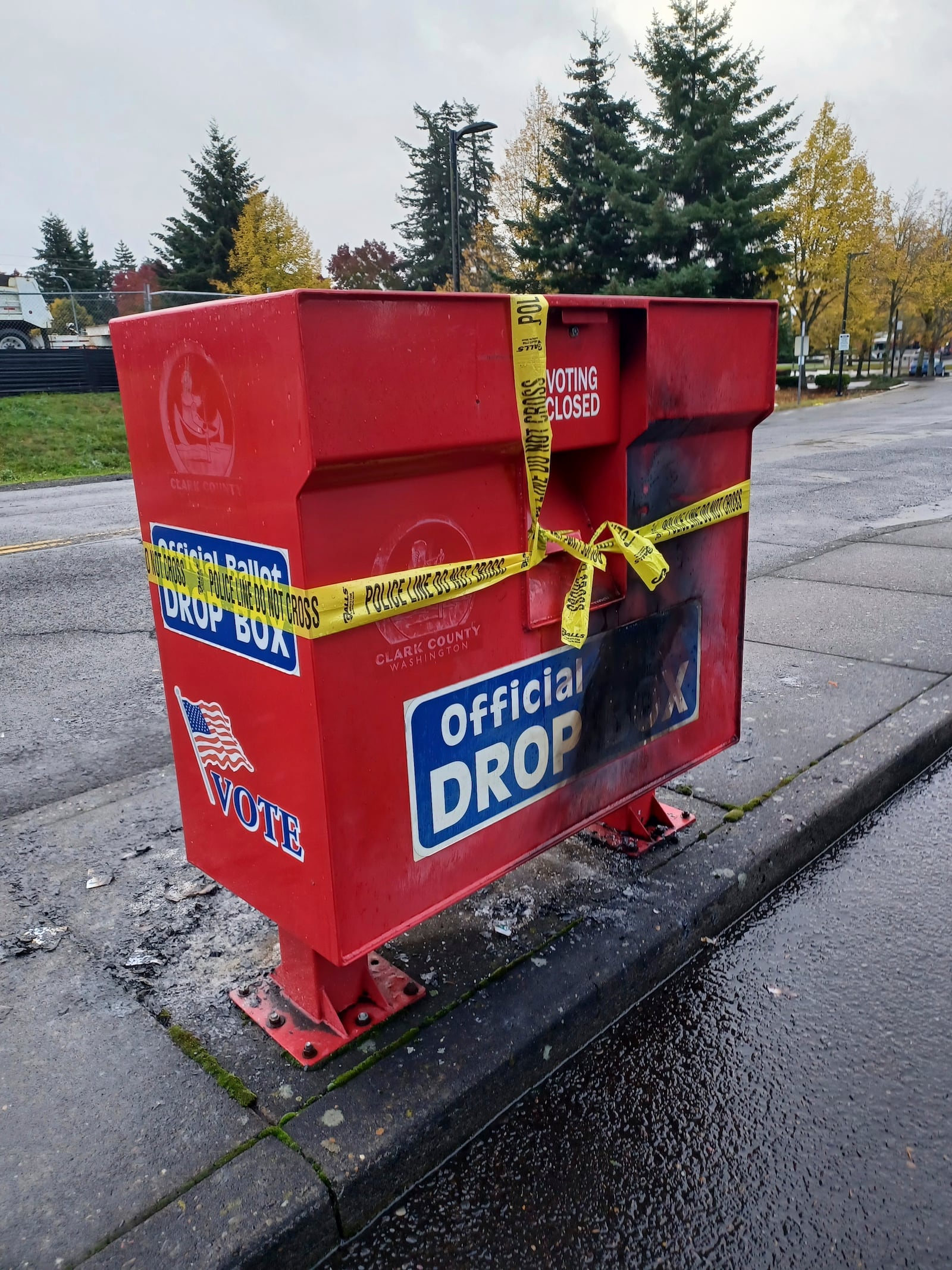 FILE - Police tape surrounds a ballot drop box damaged by a fire on Monday, Oct. 28, 2024, in Vancouver, Wash. (Monika Spykerman/The Columbian via AP, File)