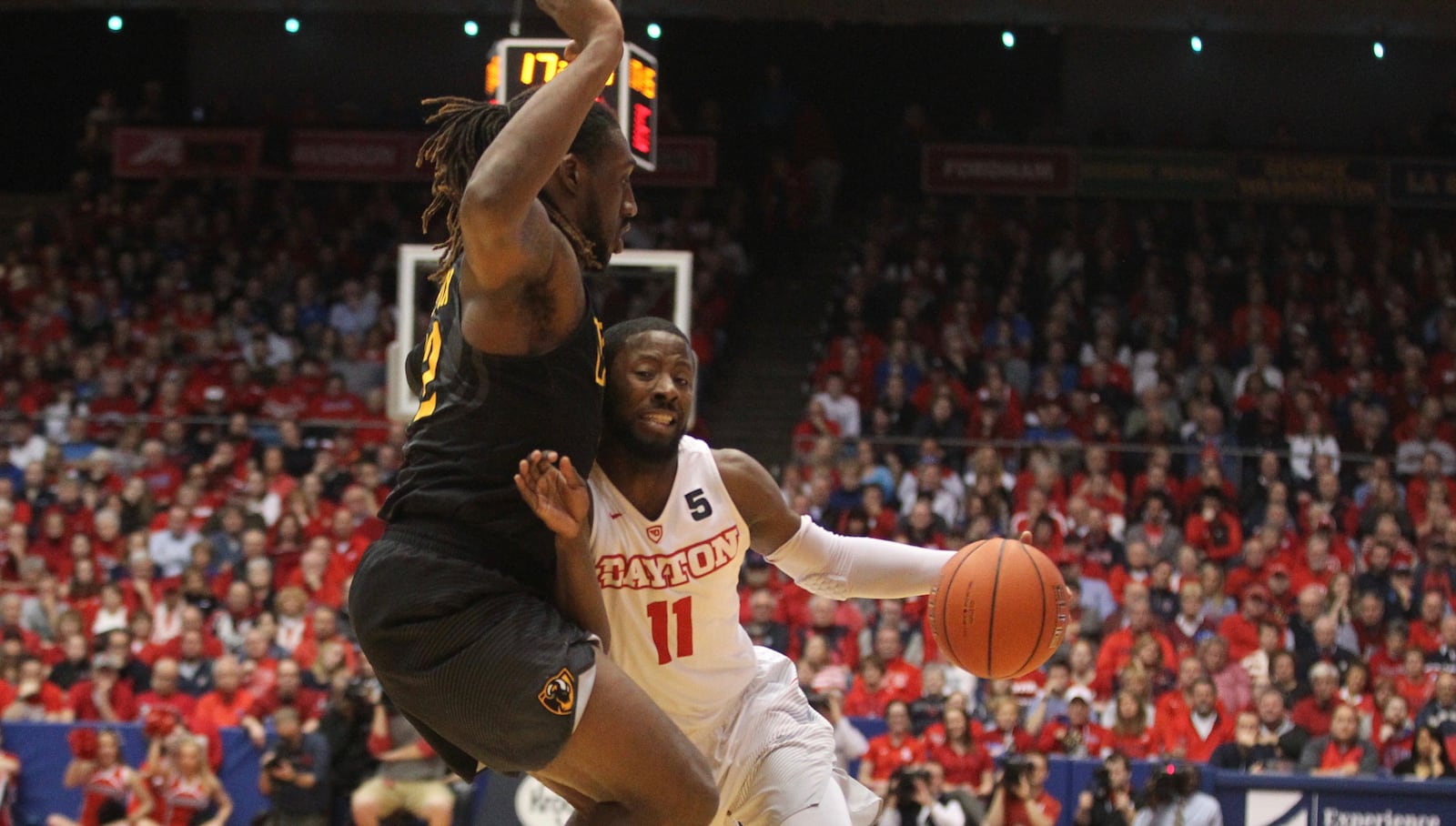 Dayton’s Scoochie Smith drives against Mo Alie-Cox of VCU in the first half (Photo: David Jablonski/CMG Ohio)