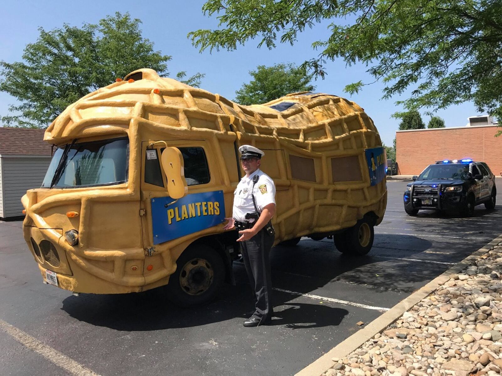 Hamilton Police stops to check out the Planters Peanuts NUTmobile parked in the parking lot of Courtyard by Marriott in Hamilton on July 12, 2018. NICK GRAHAM/STAFF