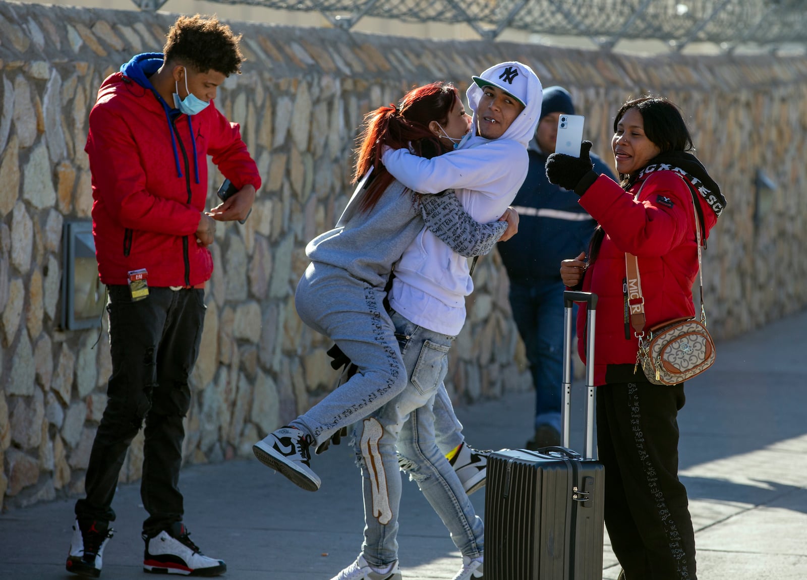 Venezuelan migrants from left; Oldris Rodriguez, Daniela Medina, Josue Fernandez and Jilbelis Sequera celebrate after entering the United States from Ciudad Juarez, Mexico through the Paso del Norte bridge, Monday, Jan. 20, 2025 in El Paso, Texas.(AP Photo/Andres Leighton)