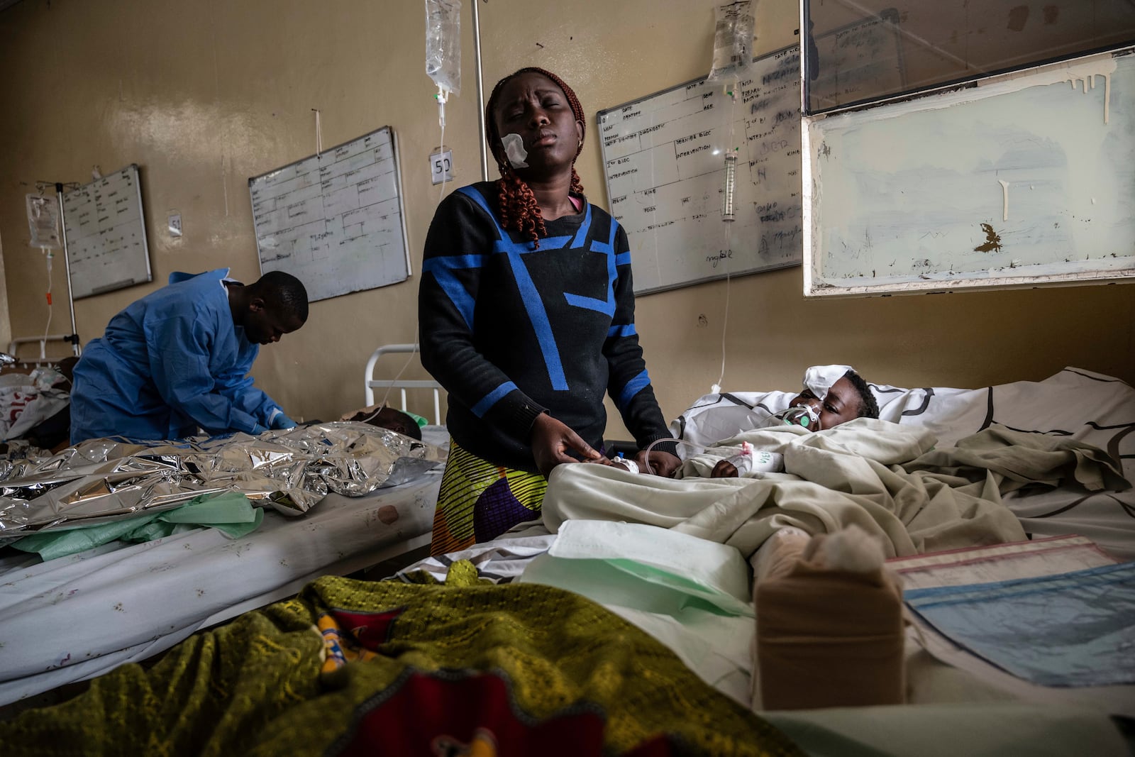 Mariam Nasibu stands by her 10-year-old daughter Deborah, who was wounded in the fighting between M23 rebels and Congolese armed forces, in Goma, Democratic Republic of the Congo, Thursday, Jan. 23, 2025. (AP Photo/Moses Sawasawa)