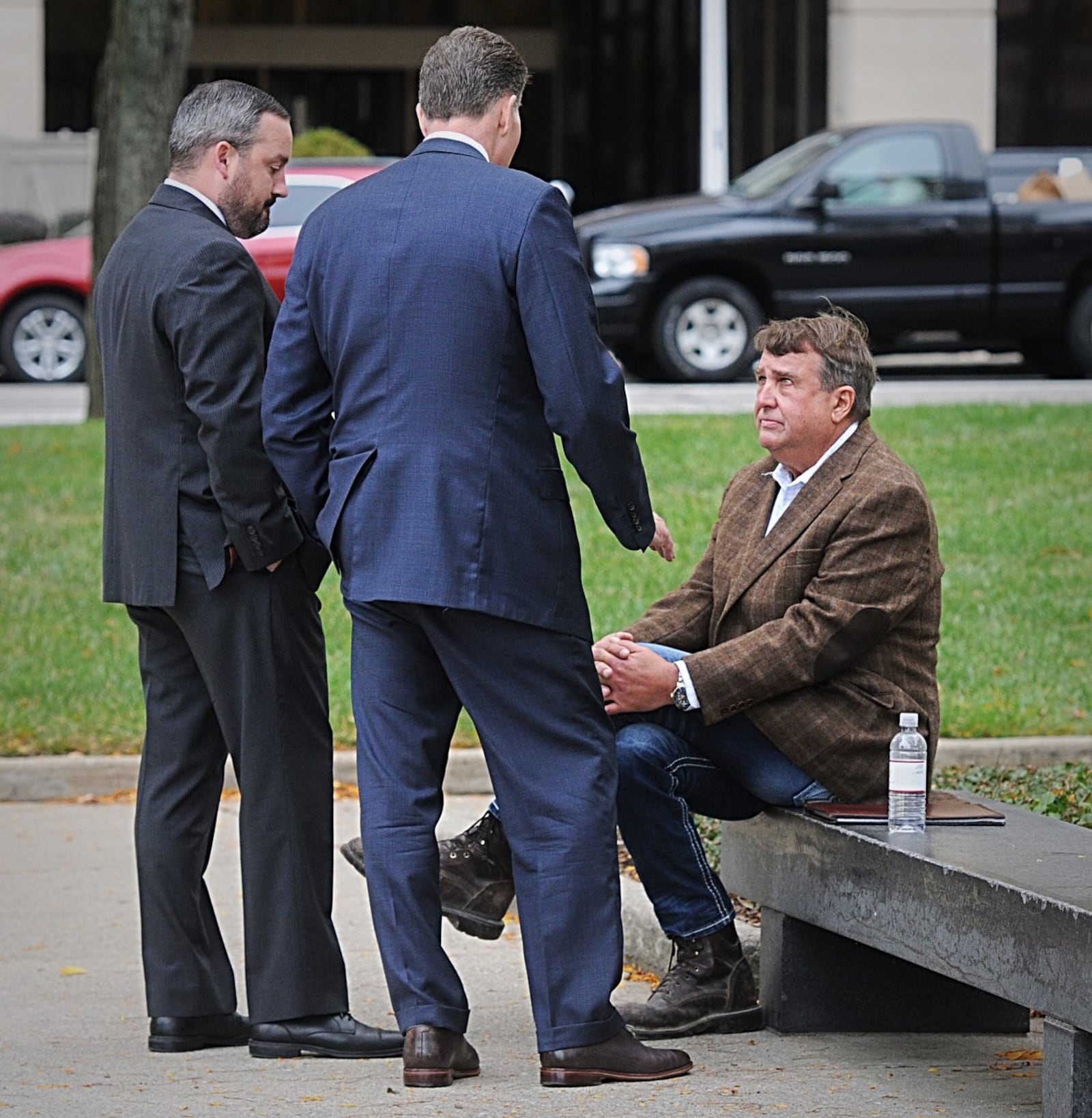 Steve Rauch (seated) confers with his attorneys prior to an earlier court appearance. MARSHALL GORBY/STAFF