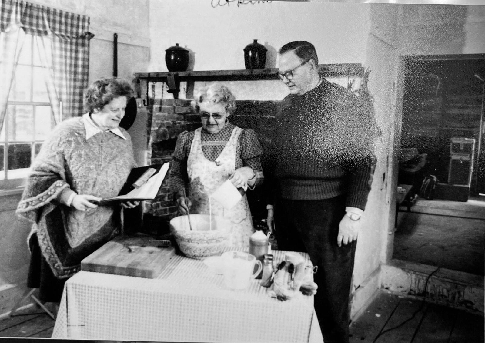 Connie Klarer (L) and her husband David (R) volunteered together at Carriage Hill Farm. They are shown with an unidentified volunteer during the filming of "The Fireplace Chef" in the 1980's, a PBS produced short about cooking over a wood fire. CONTRIBUTED