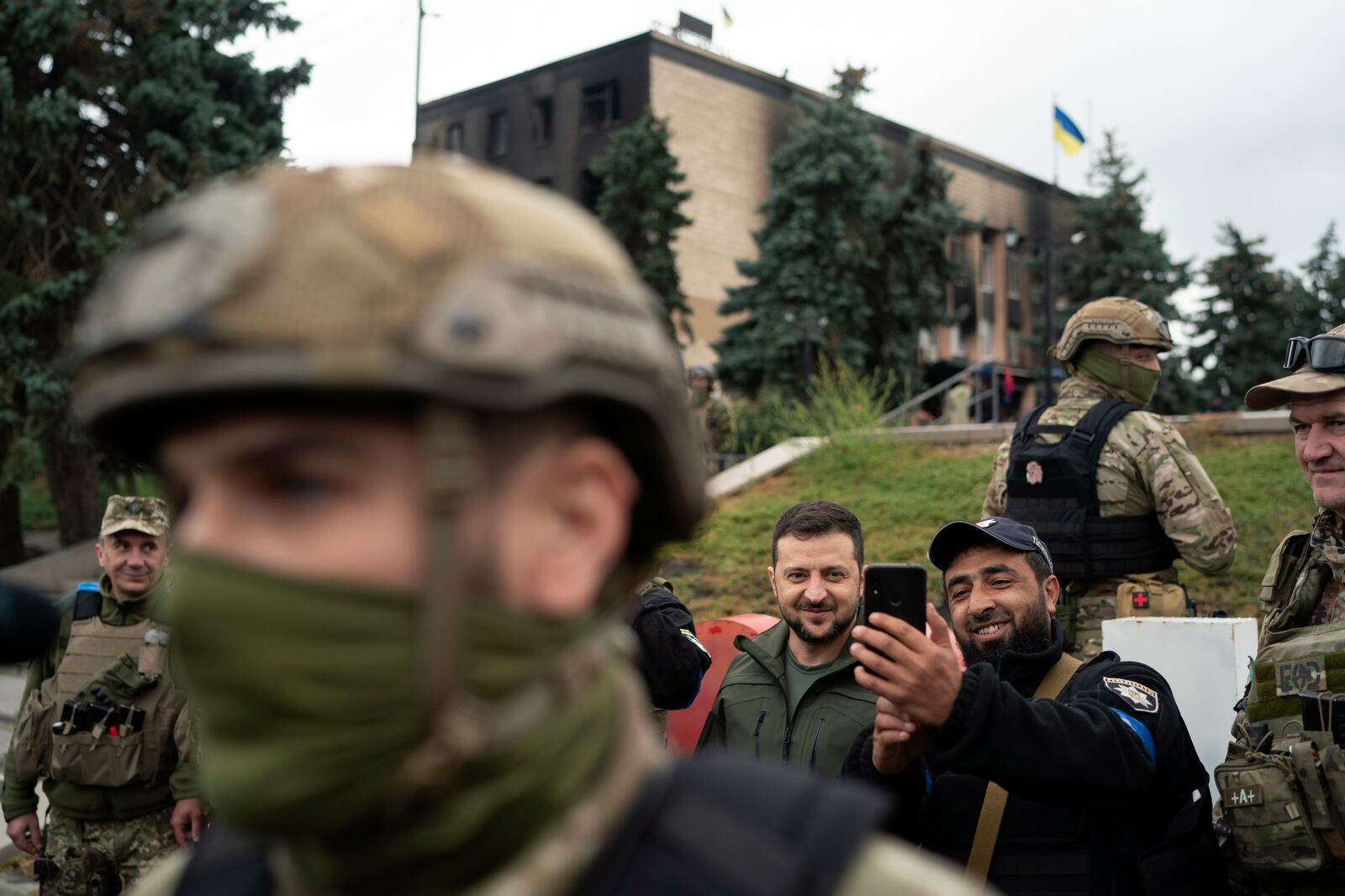 FILE - Ukrainian President Volodymyr Zelenskyy poses for a selfie with a police officer after attending a flag-raising ceremony in the city of Izium, Ukraine, on Sept. 14, 2022. (AP Photo/Leo Correa, File)