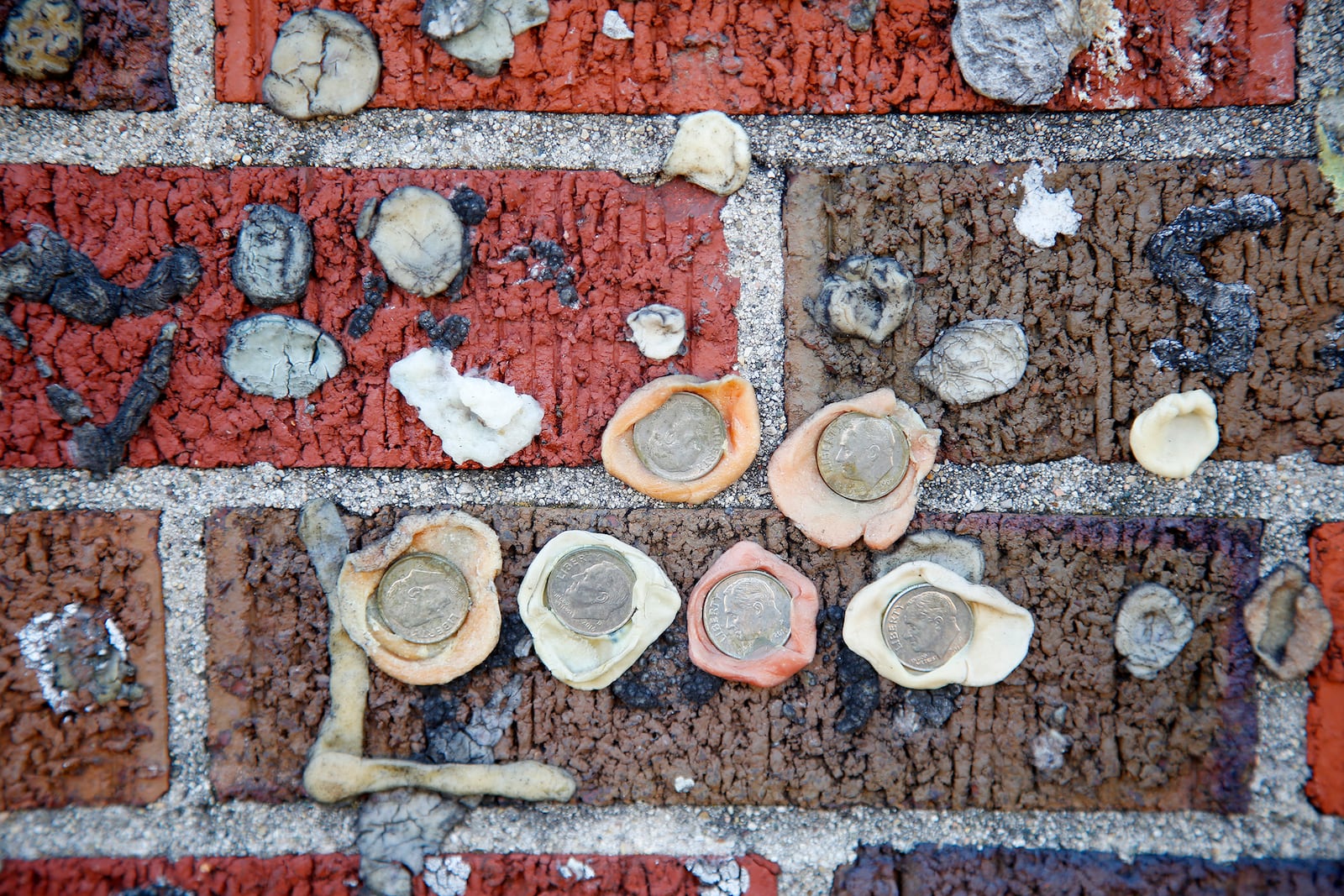 Coins, bottle caps and small pieces of paper with messages written inside have been stuck into the gum at Greenville's Maid-Rite Sandwich Shoppe. Sometimes people stretch their chewed gum into initials and declare their love. LISA POWELL / STAFF