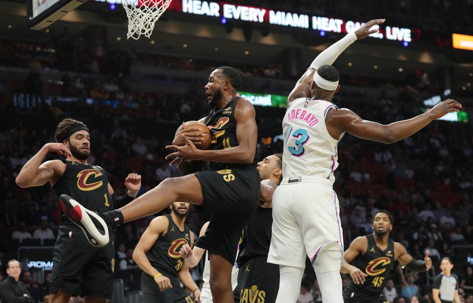 Cleveland Cavaliers forward Evan Mobley grabs a rebound in front of Miami Heat center Bam Adebayo during the first half of an NBA basketball game, Wednesday, Jan. 29, 2025, in Miami. (AP Photo/Lynne Sladky)