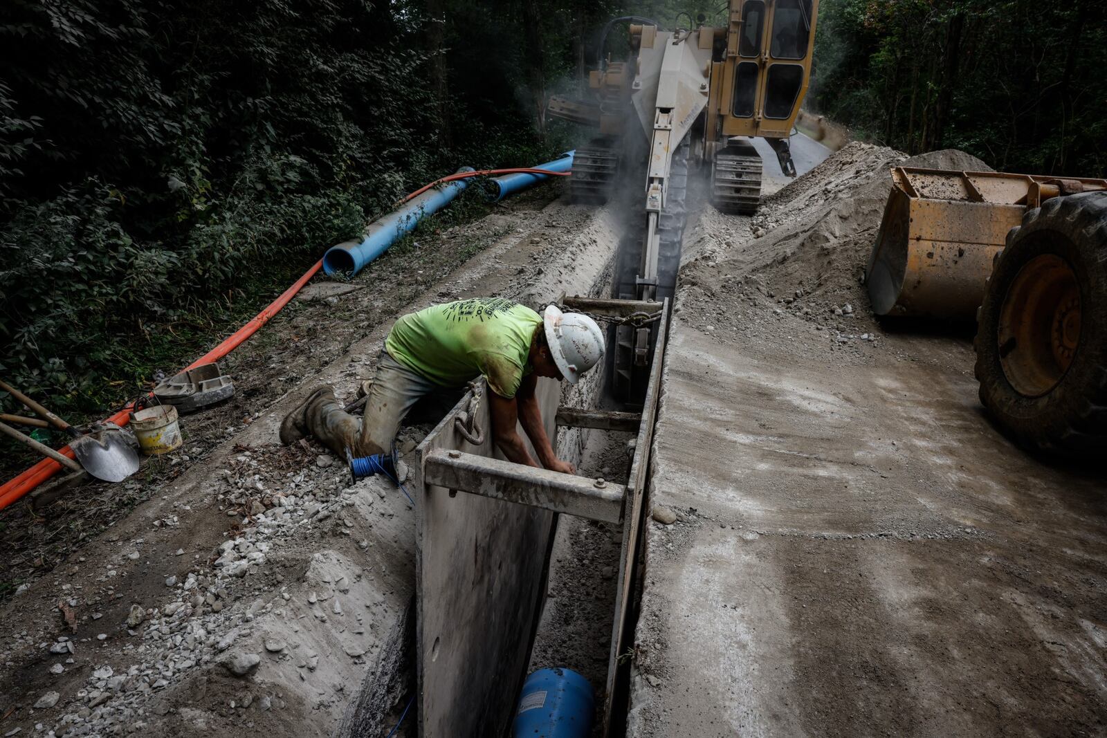 Workers cut a trench into solid rock on East Martindale Rd. in Union to install a watermain for homeowners that are on there own private wells. JIM NOELKER/STAFF