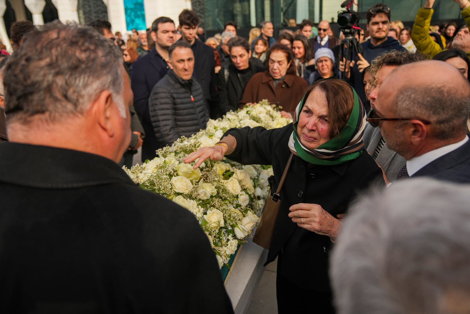 Relatives mourn during the funeral of three members of the Inal family, who died in a fire that broke out at the Kartalkaya ski resort, at the Barbaros Hayreddin Pasa mosque in Istanbul, Turkey, Friday, Jan. 24, 2025. (AP Photo/Francisco Seco)