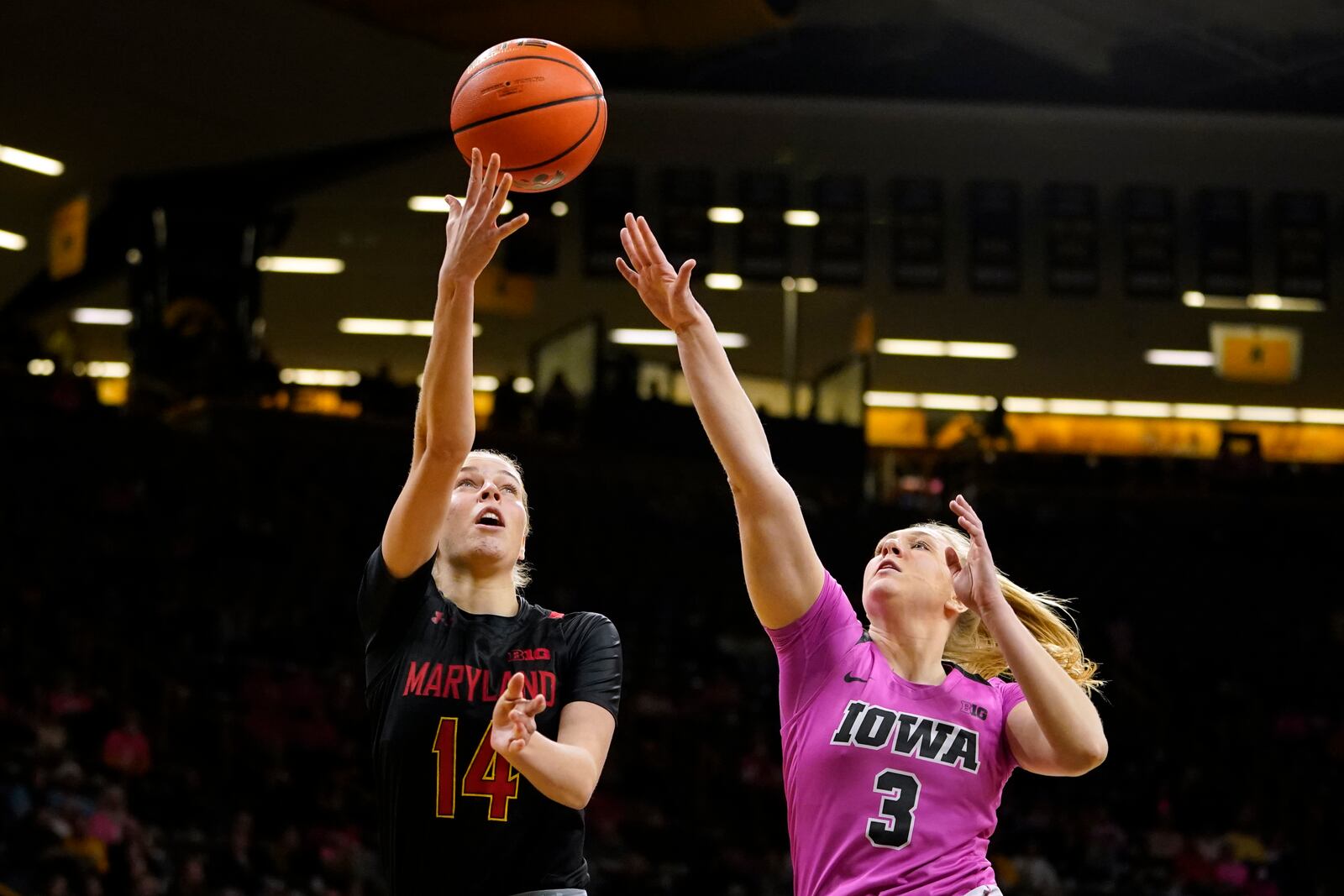 Maryland guard Taisiya Kozlova (14) drives to the basket ahead of Iowa guard Sydney Affolter (3) during the first half of an NCAA college basketball game, Monday, Feb. 14, 2022, in Iowa City, Iowa. (AP Photo/Charlie Neibergall)