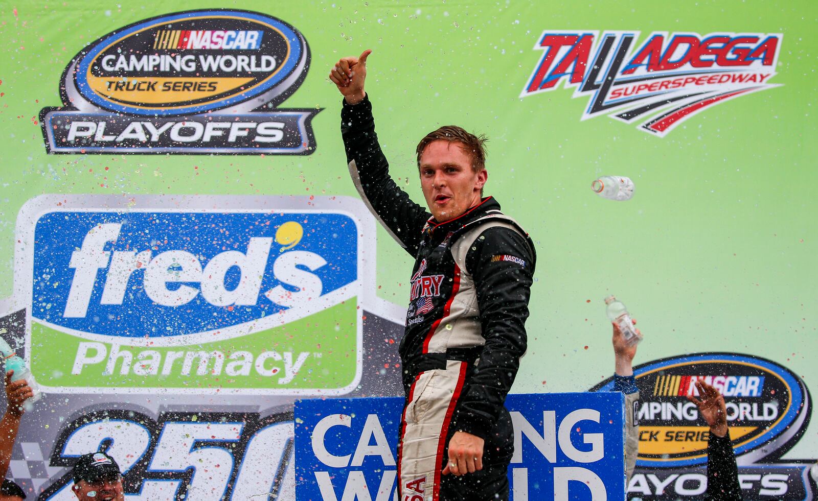 FILE - Parker Kligerman (75) celebrates in Victory Lane after winning the Fred's 250 Camping World Truck Series race at Talladega Superspeedway, Saturday, Oct. 14, 2017, in Talladega, Ala. (AP Photo/Butch Dill, File)