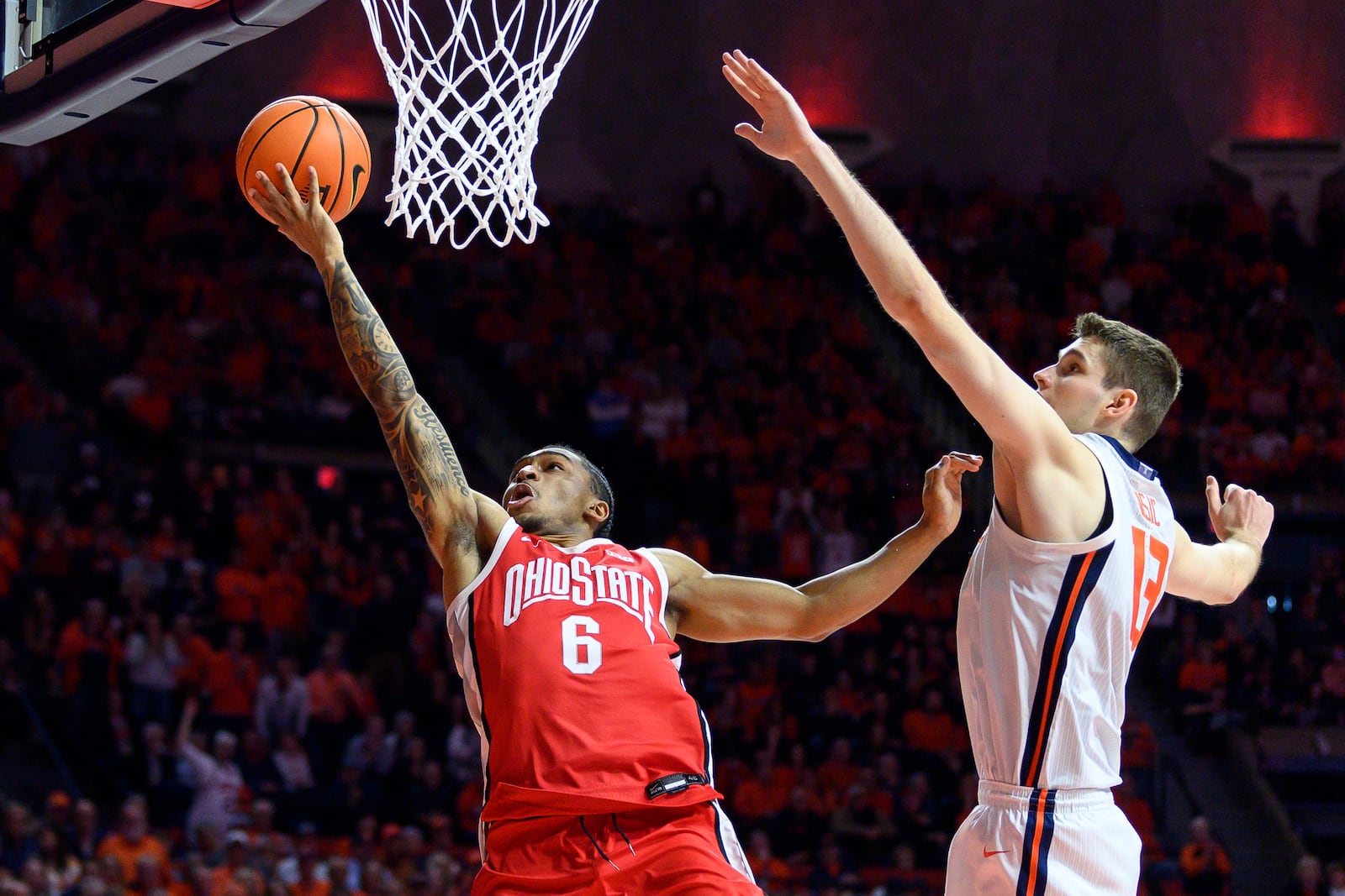 Ohio State's Ques Glover (6) shoots as Illinois' Tomislav Ivisic, right, defends during the second half of an NCAA college basketball game Sunday, Feb. 2, 2025, in Champaign, Ill. (AP Photo/Craig Pessman)