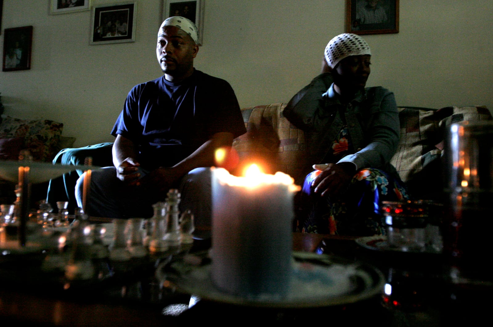 Stephen Owens (left) and Krisiti Wallace (right) use candles and leave the front door open to let light into their basement apartment at Westbrooke Village Apartments in Trotwood Sunday Sept. 21. About 20 residents held a protest earlier in the day because they have been without power for a week since a windstorm came through the area Sept. 14. Staff photo by Lisa Powell