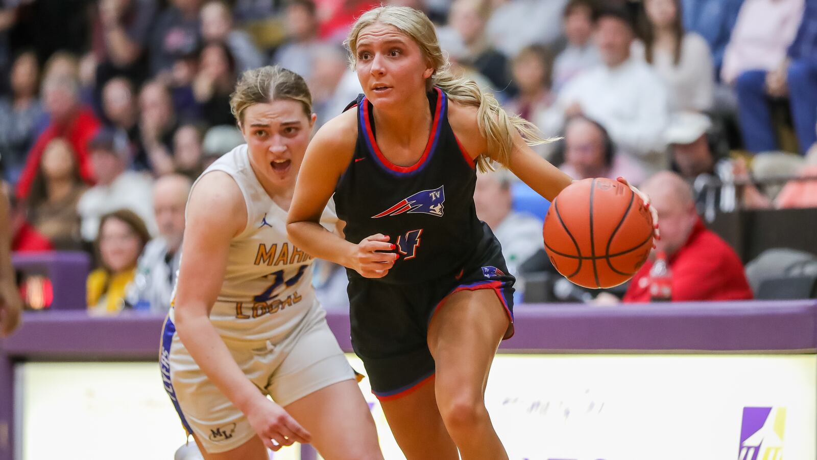 Tri-Village High School senior Rylee Sagester drives past Marion Local sophomore Chloe Ronnebaum during their Division IV regional semifinal game on Thursday night at the Vandalia Butler Student Activity Center. CONTRIBUTED PHOTO BY MICHAEL COOPER