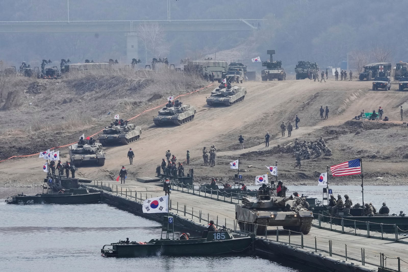 A South Korean army K1E1 tank crosses a floating bridge on the Imjin River during a joint river-crossing exercise between South Korea and the United States as a part of the Freedom Shield military exercise in Yeoncheon, South Korea, Thursday, March 20, 2025. (AP Photo/Ahn Young-joon)