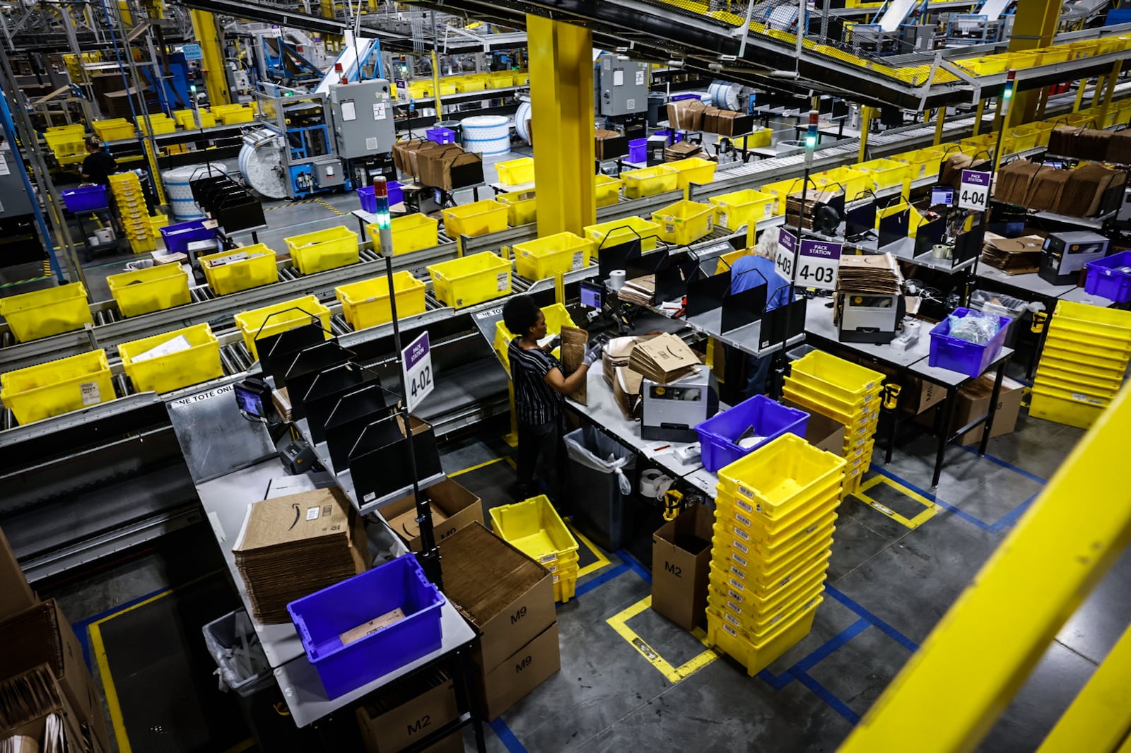 Workers at the Amazon Union Fulfillment Center work with packages during an open house Thursday August 21, 2024. JIM NOELKER/STAFF