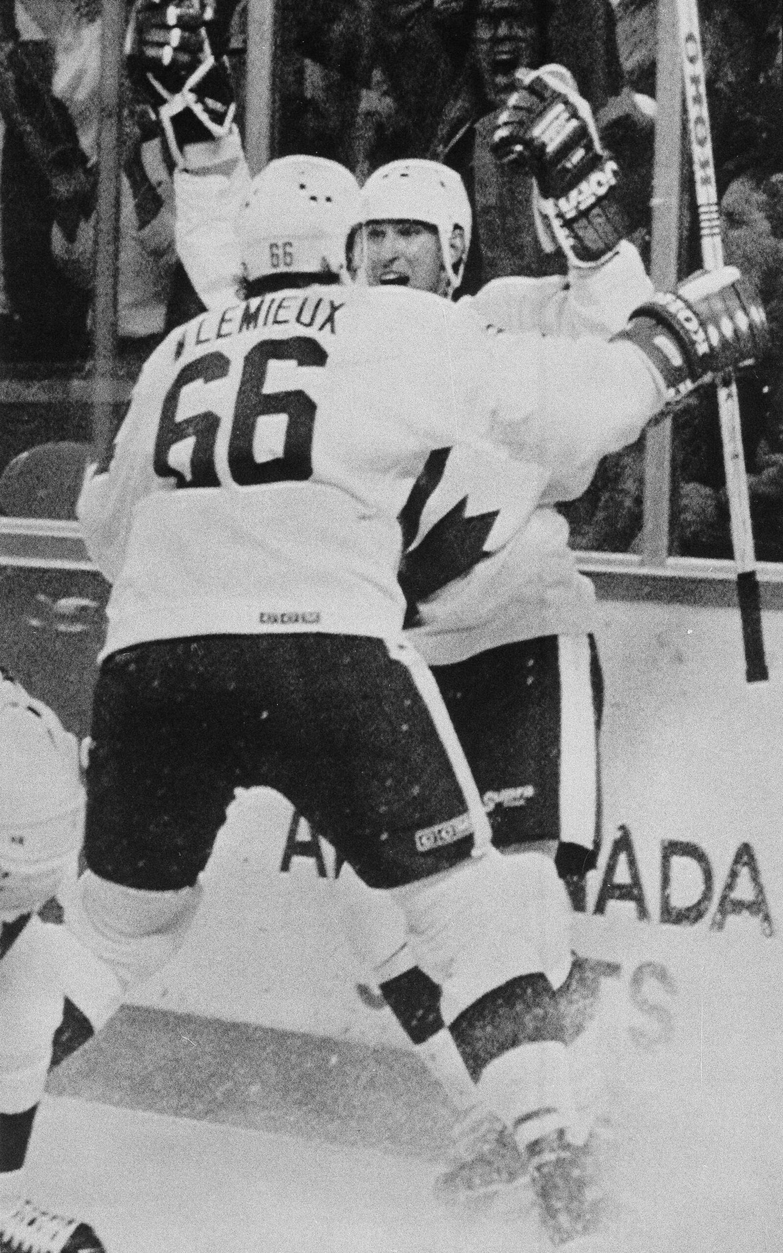 FILE - Canada's Mario Lemieux rushes into the arms of teammate Wayne Gretzky after Gretzky scored the game-winner in their Canada Cup final match against the Soviet Union, Sept. 15, 1987, in Hamilton, Ontario. (AP Photo/Blaise Edwards, File)