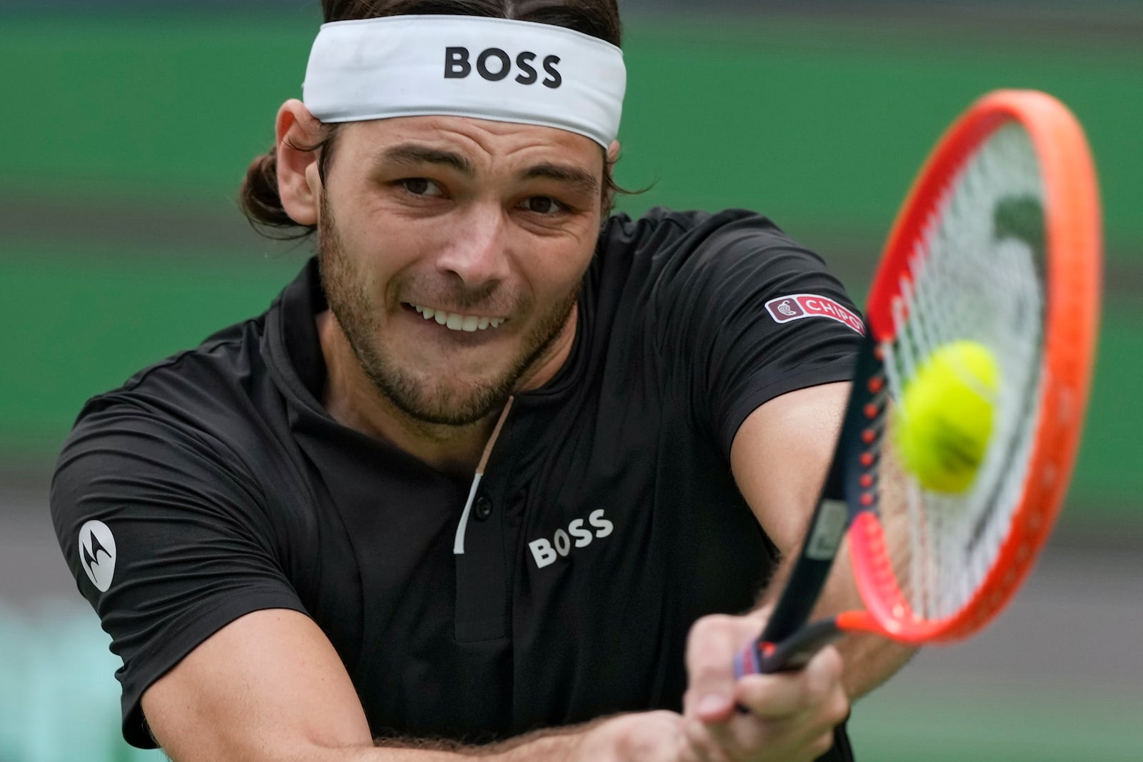 Taylor Fritz of the United States plays a backhand return against David Goffin of Belgium during the men's singles quarterfinals match in the Shanghai Masters tennis tournament at Qizhong Forest Sports City Tennis Center in Shanghai, China, Friday, Oct. 11, 2024. (AP Photo/Andy Wong)