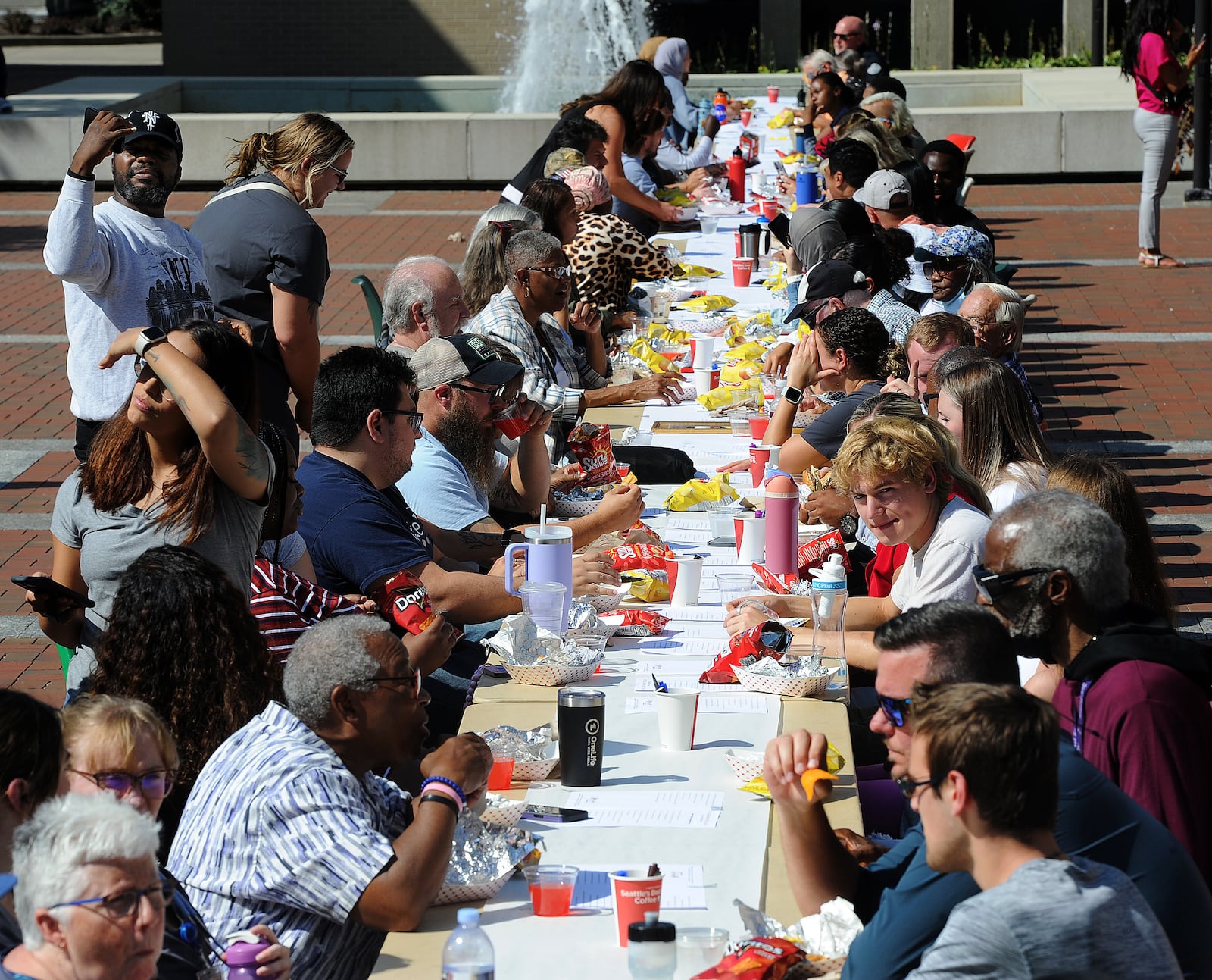 People from all over the city of Dayton enjoyed a free meal at the longest table event at Sinclair College, Wednesday, Sept. 20, 2023. MARSHALL GORBY\STAFF