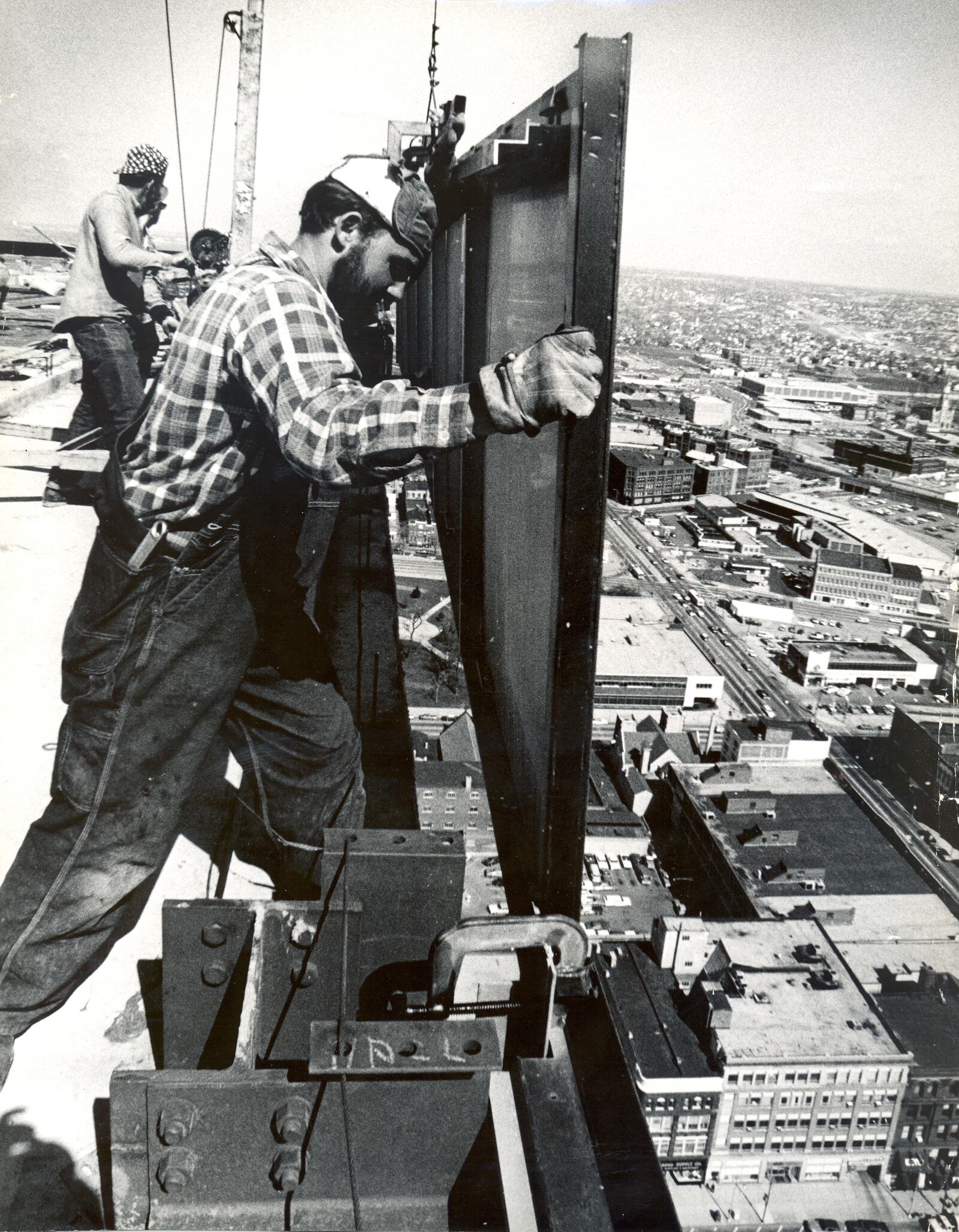 Tom Schaaf of B.G. Danis Co. guides the final wall panel into place on the 30-story Winters Bank Tower, today called the Kettering Tower. The aluminum and bronze panel measured 28 feet by 5 feet and weighed about 500 pounds. DAYTON DAILY NEWS ARCHIVE April 23, 1971.